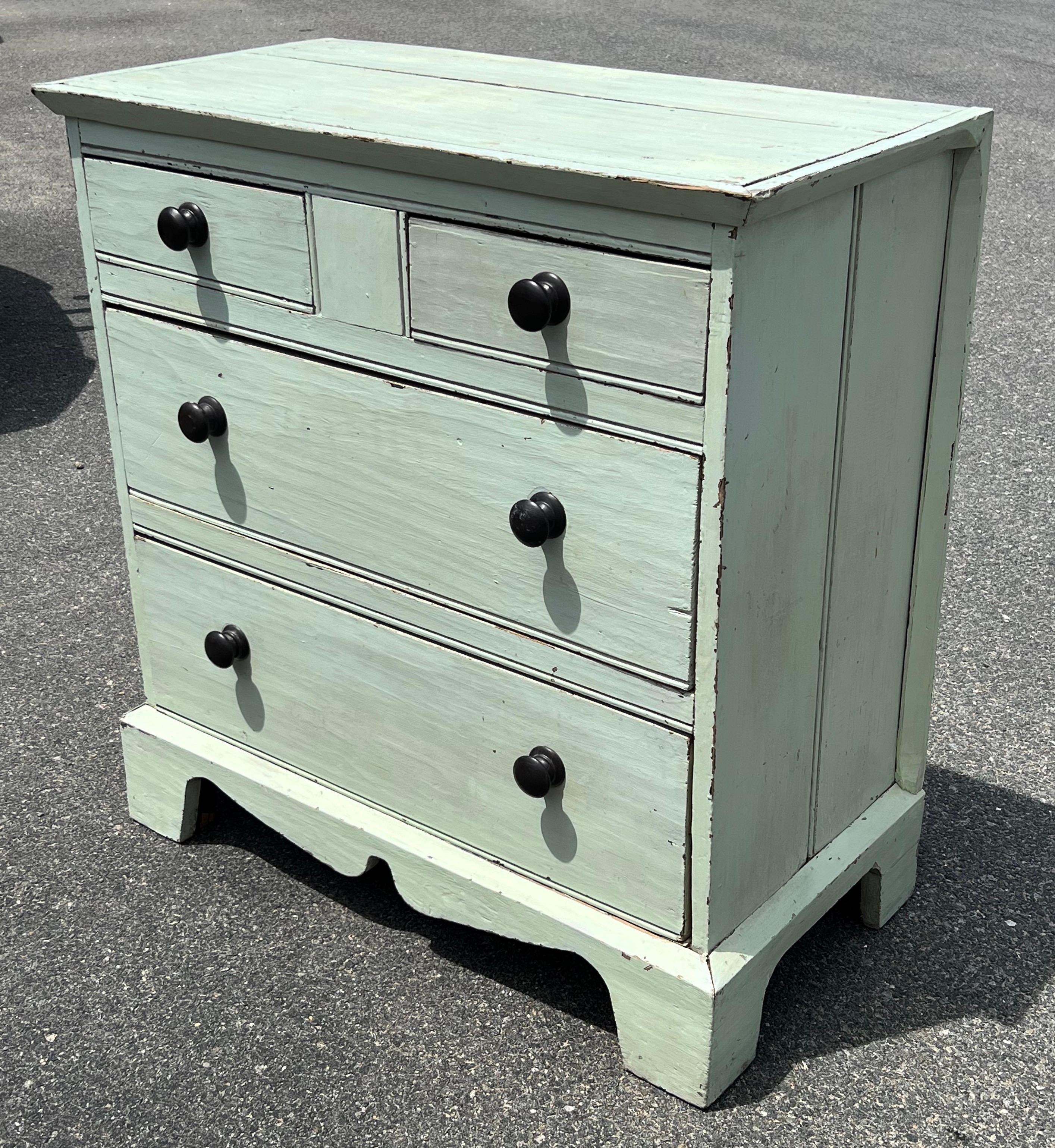 19th century Pine dresser with two side-by-side drawers over two lower drawers, beaded two-board sides and shaped, bracket base. In original mint green paint with black wood knobs.