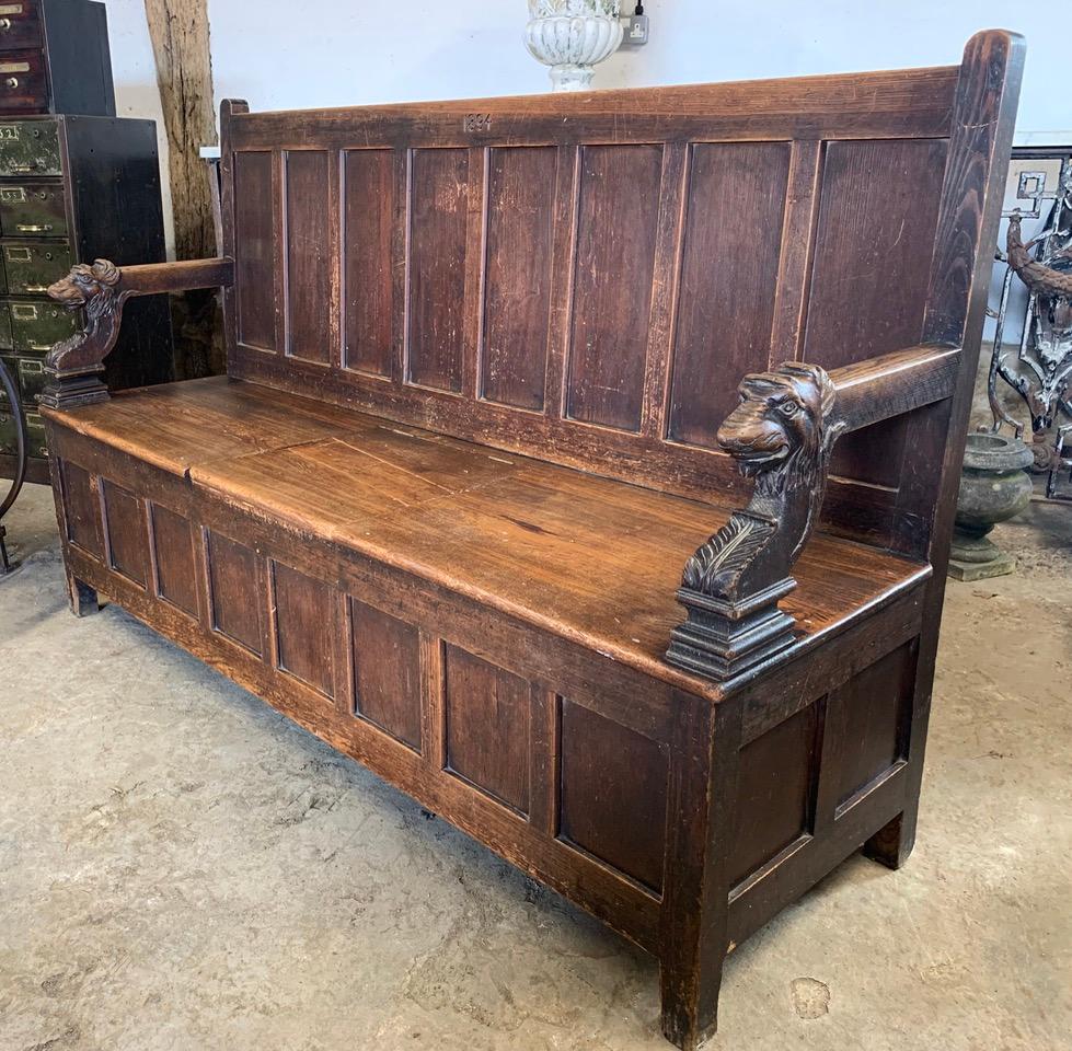 A 19th century pine settle dated 1894 on the back. With two carved dogs heads on the arms. Flap on the seat for storage. Old repair on the seat flap but still in useable condition.
Please contact us for an accurate shipping quote.