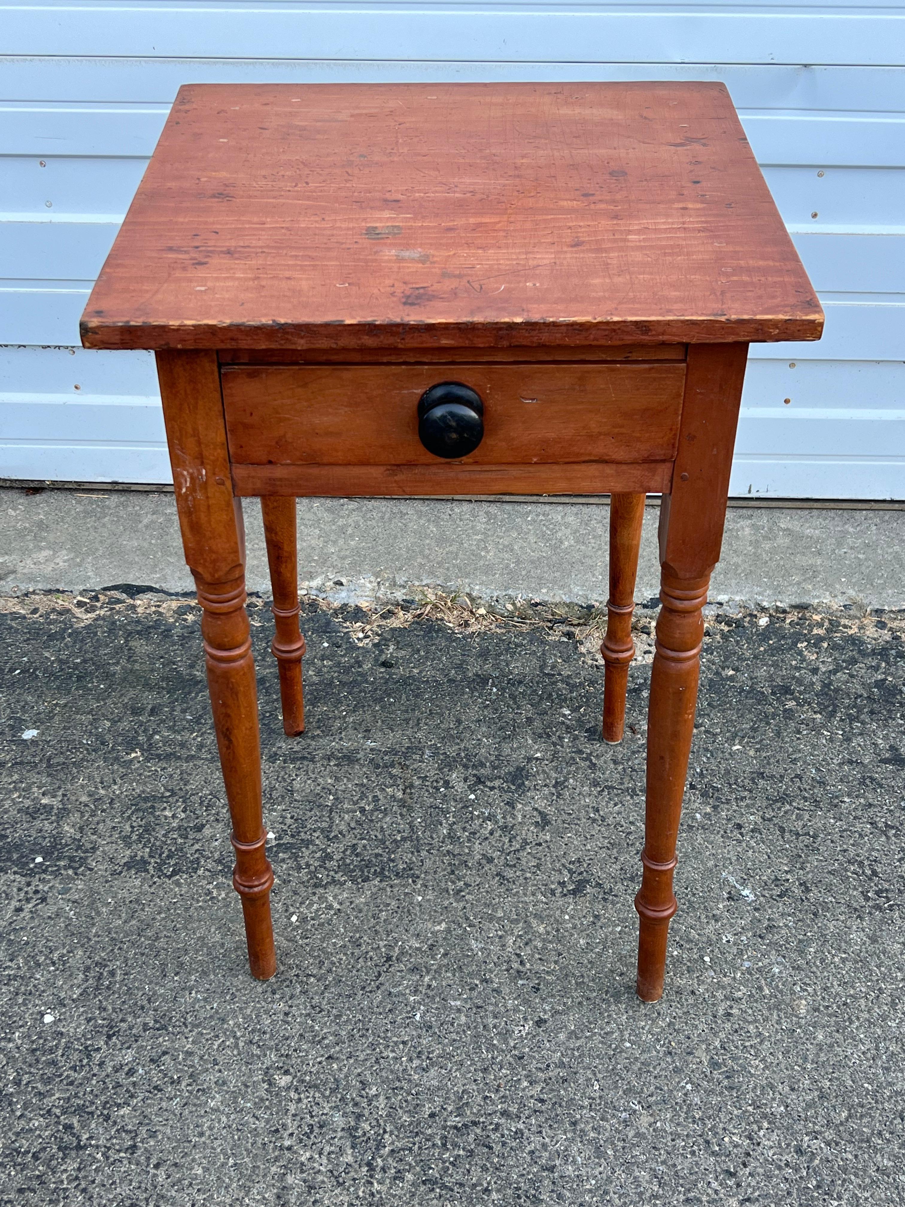 19th century one drawer stand with single board top, black painted turned drawer knob, on delicately turned legs.