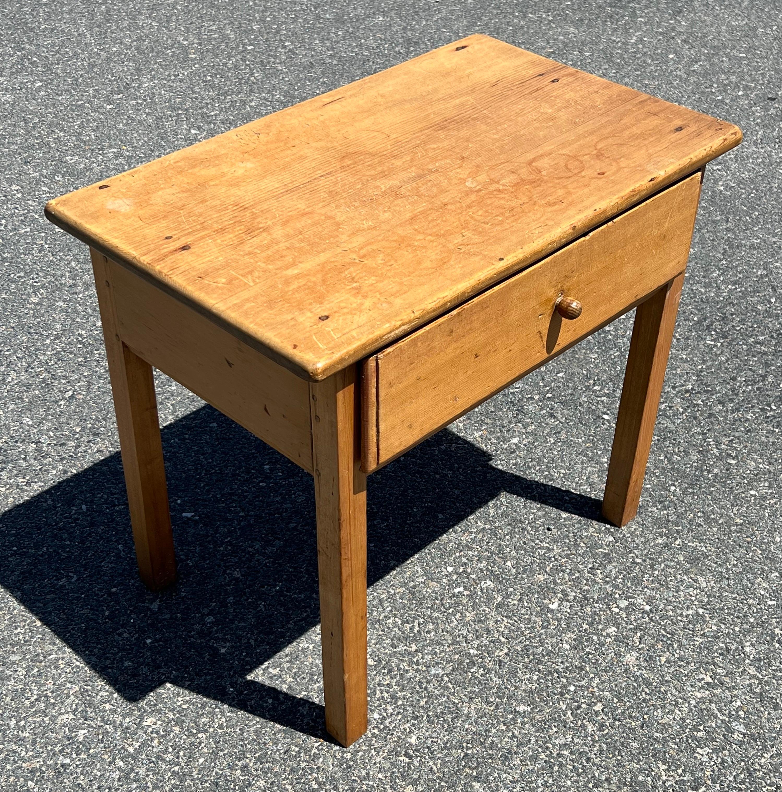 19th Century Pine Stand in natural finish with pegged construction, single drawer with large molded edge, ending on tapered legs.