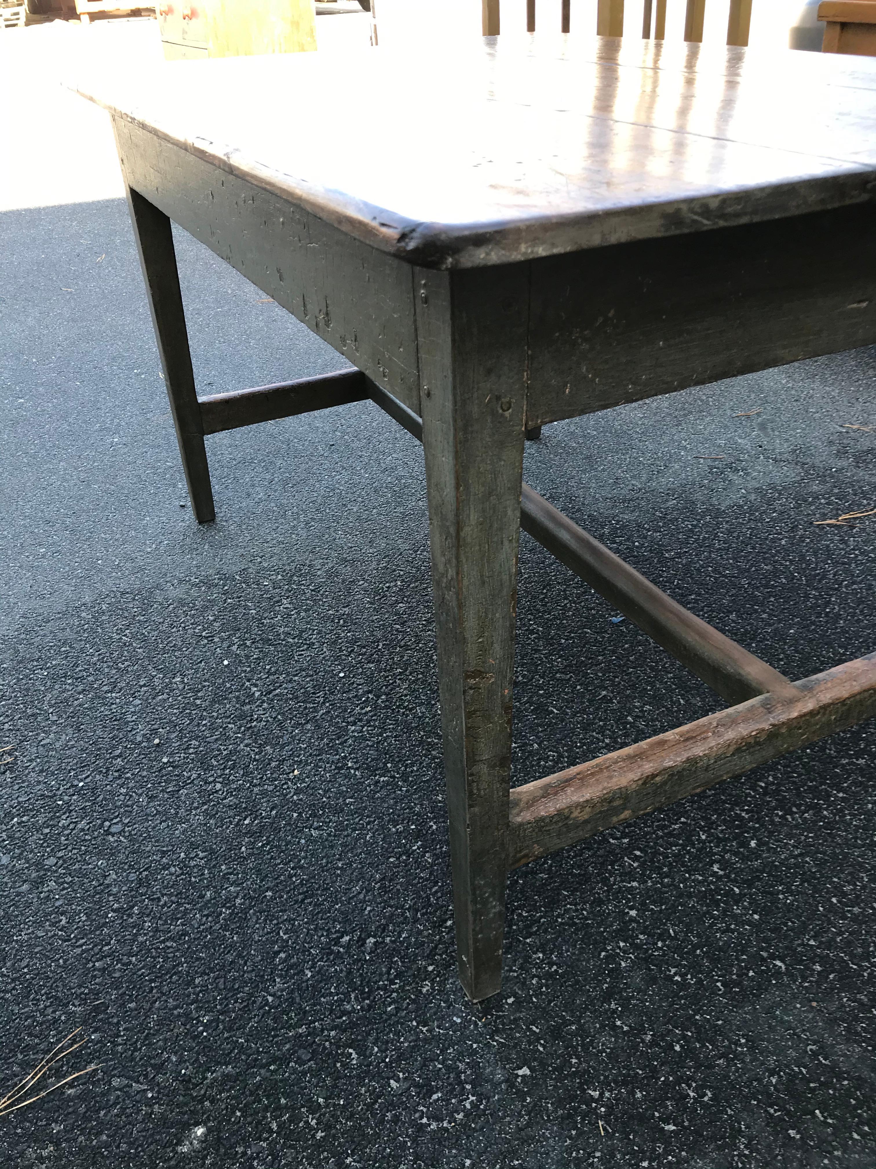 19th century Pine farm table with three board top (with old repairs), grey/green painted base with single drawer on one end, taper legs, and H stretcher.