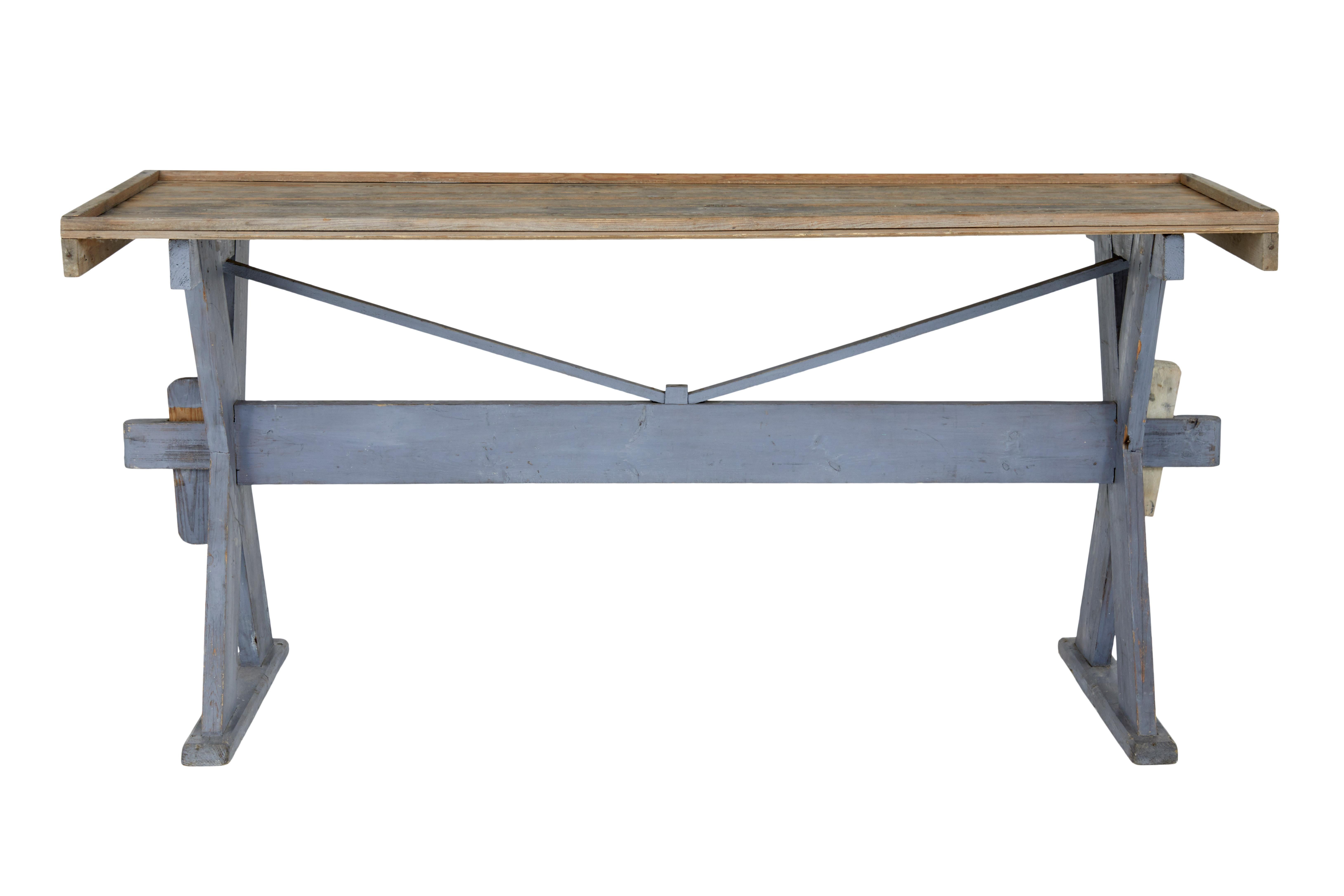 19th century pine X-frame painted work table, circa 1890.

Tongue and groove pine top with raised table edge. Top stands on a X-frame painted base held in place by stretcher and pegs.

Rustic Swedish piece, ideal for use in the conservatory or