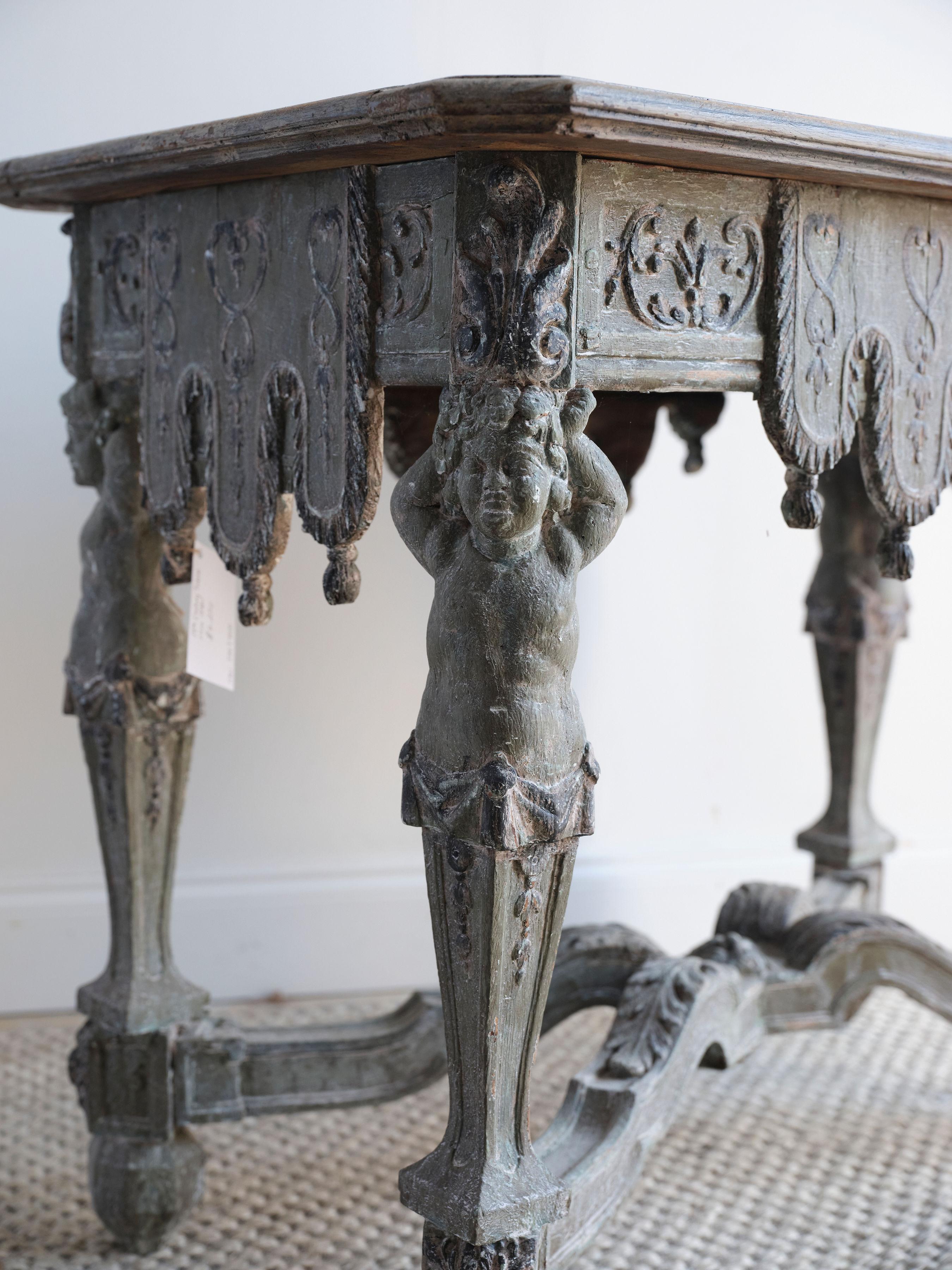 This stunning Renaissance style console table has so many unique wood carved details. It is truly one of a kind. Each leg of the table features the carving of a young child carrying the table base on its head. The table was created with pinewood and