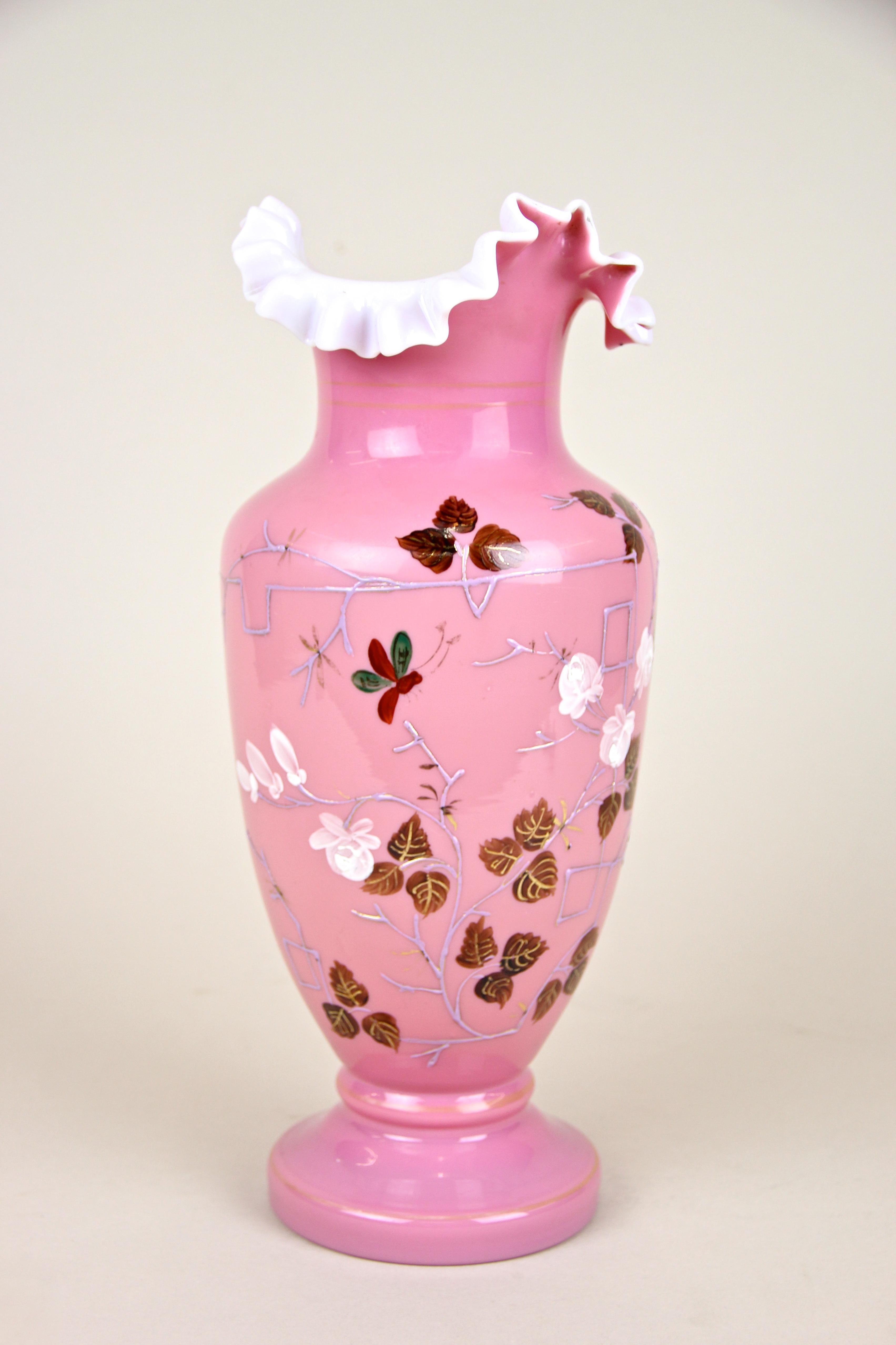 Unusual 19th century pink glass vase with enamel paintings coming from Austria, circa 1890. The bulbous mouthblown body shows painted leaves and a butterfly as well as some additional enamel paintings. The vases´s neck captivates with its white,
