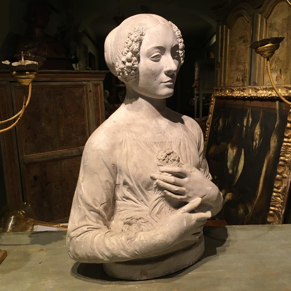 A beautiful Italian plaster bust depicting a female figure with flowers.
The bust is a 19th century's copy of the 