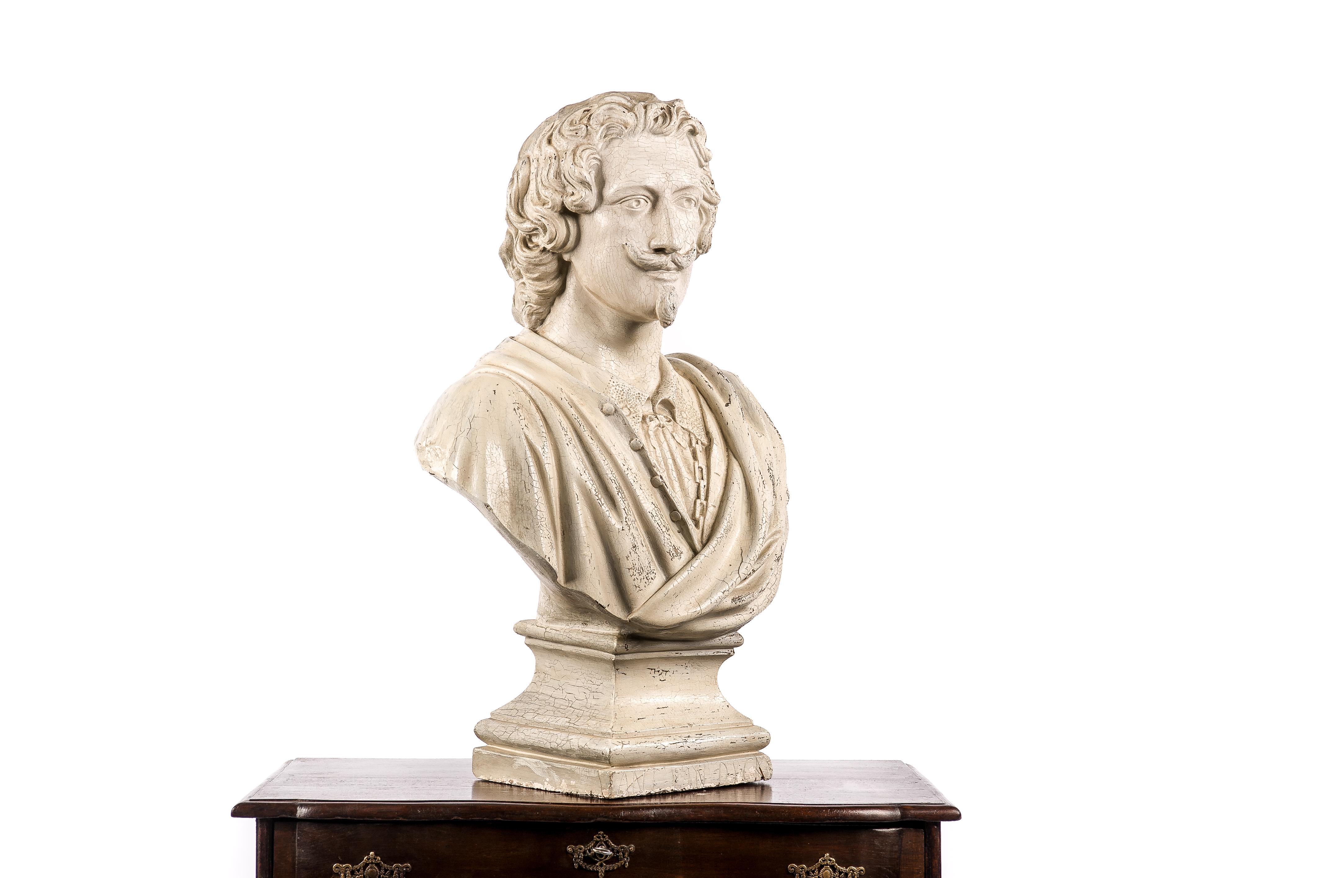 This beautiful bust of the famous Flemish artist Anthony van Dyck was cast in the late 19th century. The bust depicts the painter in his glory days wearing a rich period outfit. The bust shows multiple layers of cracked white paint with rich patina