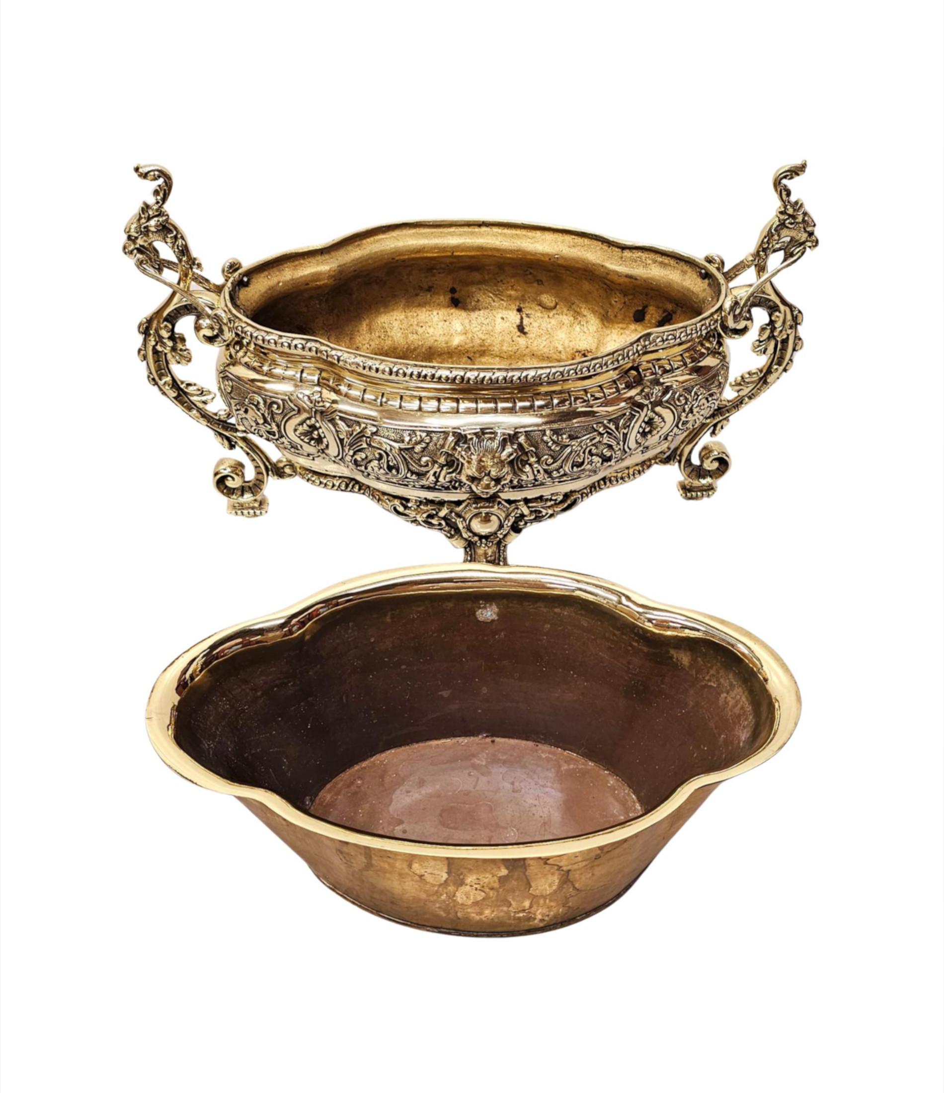 A very rare 19th Century finely cast polished brass jardiniere or planter of oval serpentine form in excellent condition with detachable liner.  This stunning piece is ornately embossed throughout with gorgeous beading, fluting, guilloche and a