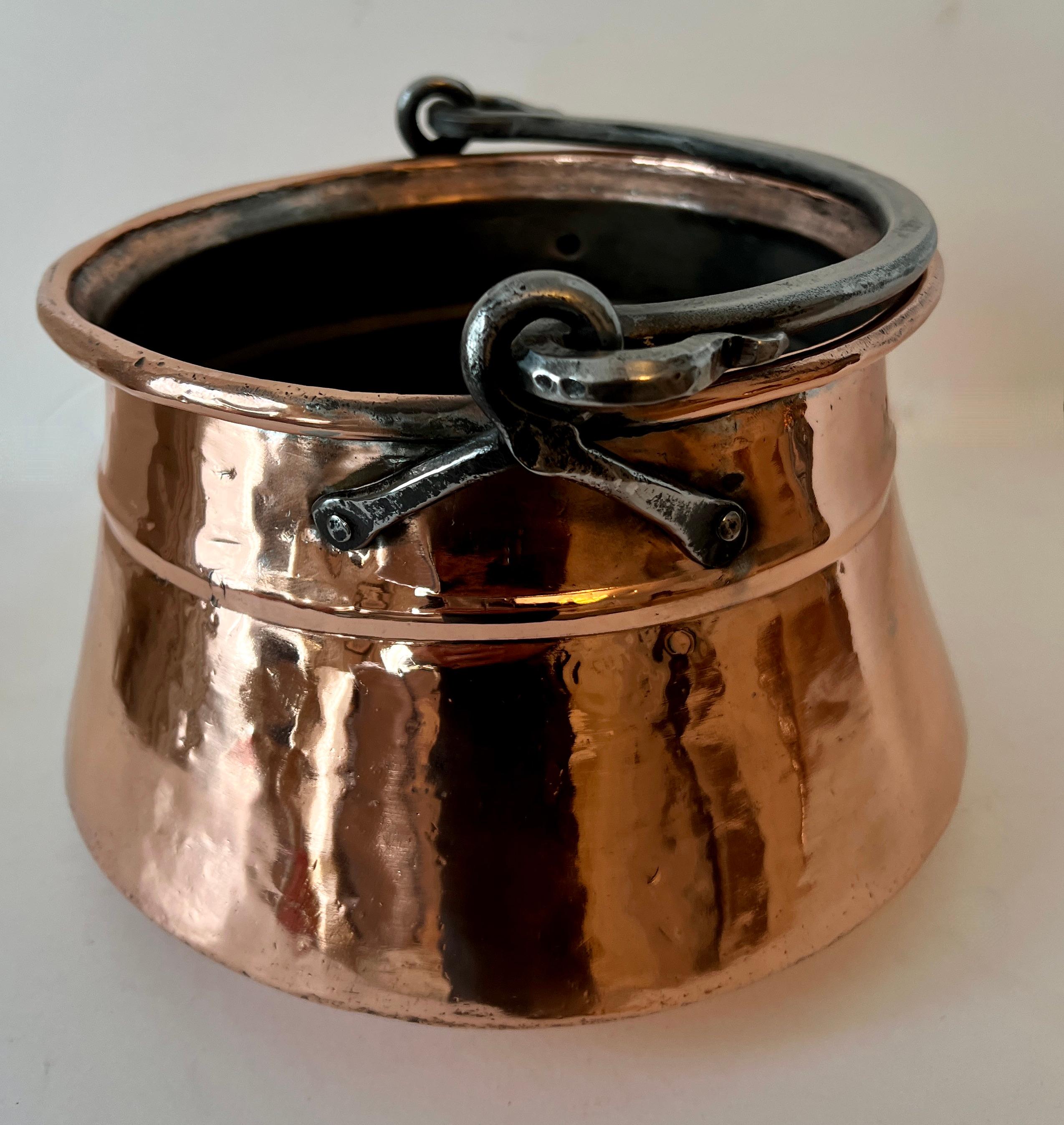 a Wonderful fully operational copper cooking pot from the 19th century, fully restored and polished.  

We love this hanging in a snappy new kitchen for show, or using it to cook soup for your homeless friends.. or you can use this in any room to