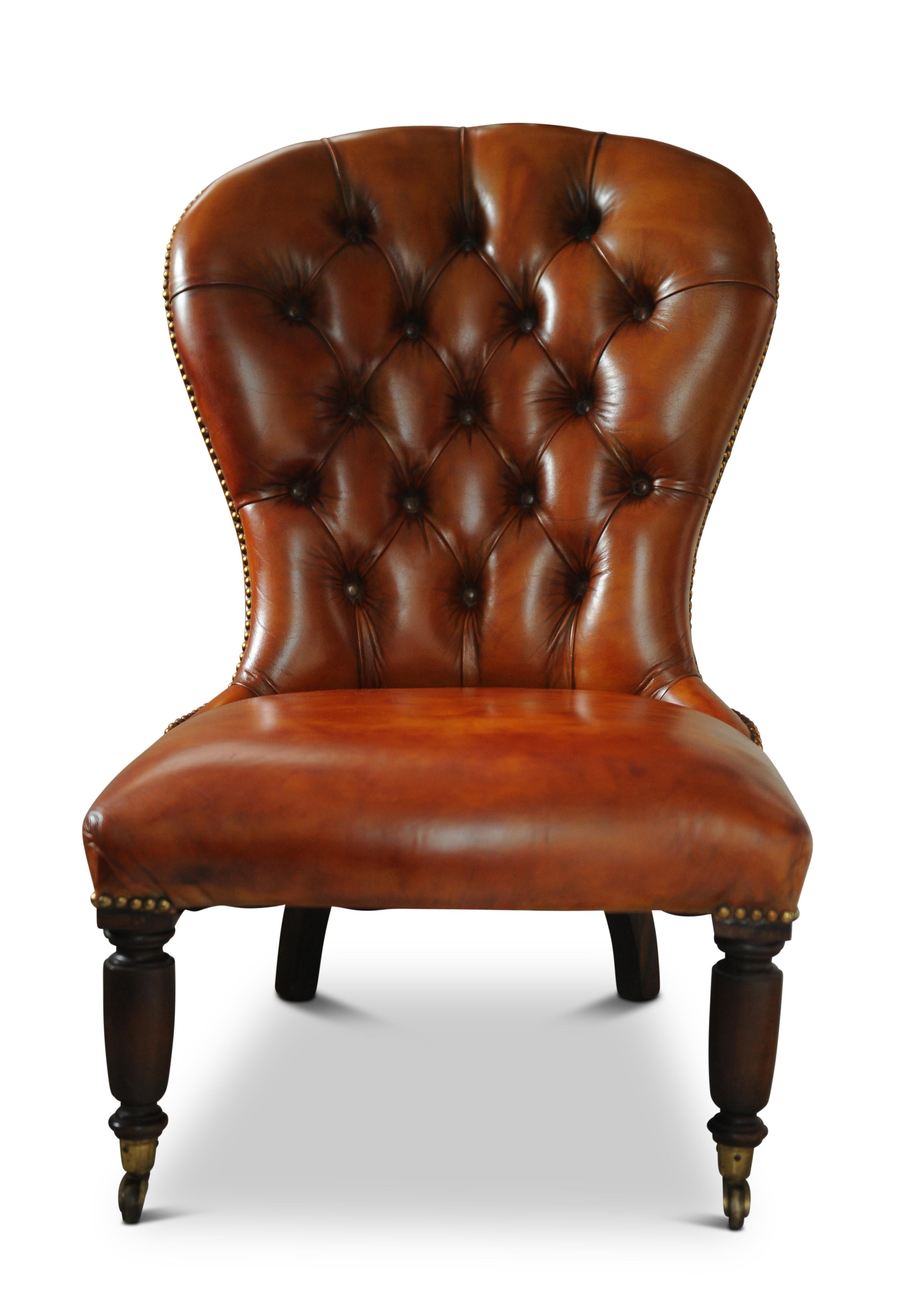 19th century polished tan leather Chesterfield Library chair with brass stud detailing on brass castors.
 