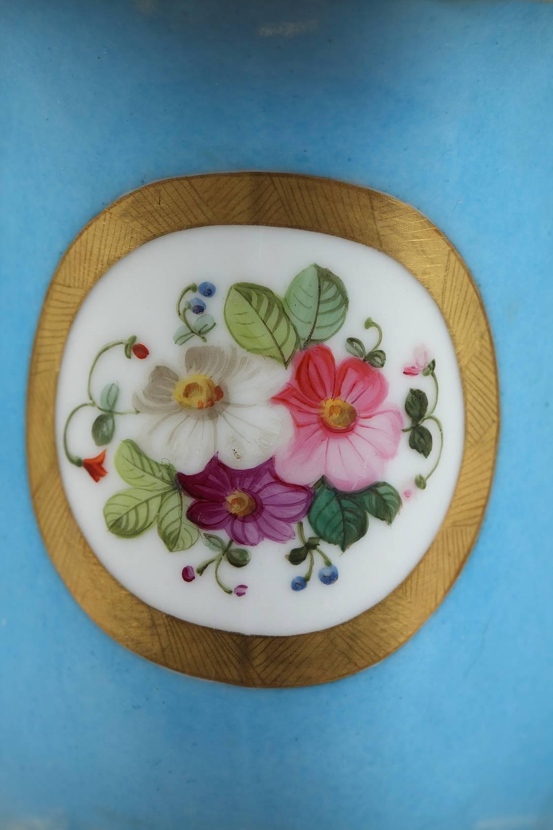 Napoleon III oval, light blue porcelain jardinière. It is decorated with polychromatic floral motifs on white medallions framed in a gold-colored border. The piece rests on a gilt bronze rocaille base. Marked underneath in green: L,

circa