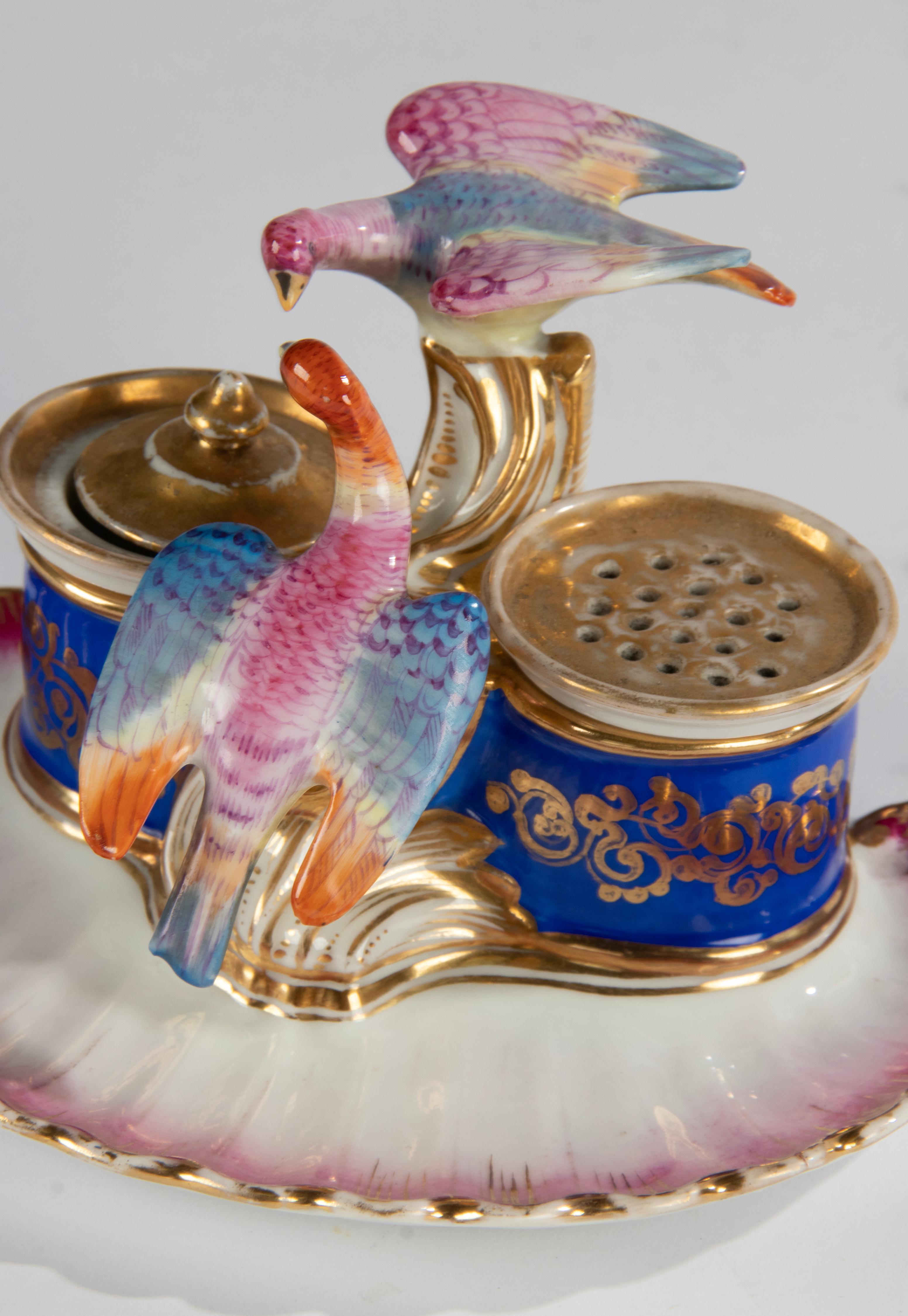 A beautiful porcelain inkwell, very decorative with colorful birds and gold colored accents. This object is not marked, but the style and design indicate that this is 'Vieux Paris' porcelain, which is rarely marked. 
The inkwell is in very good