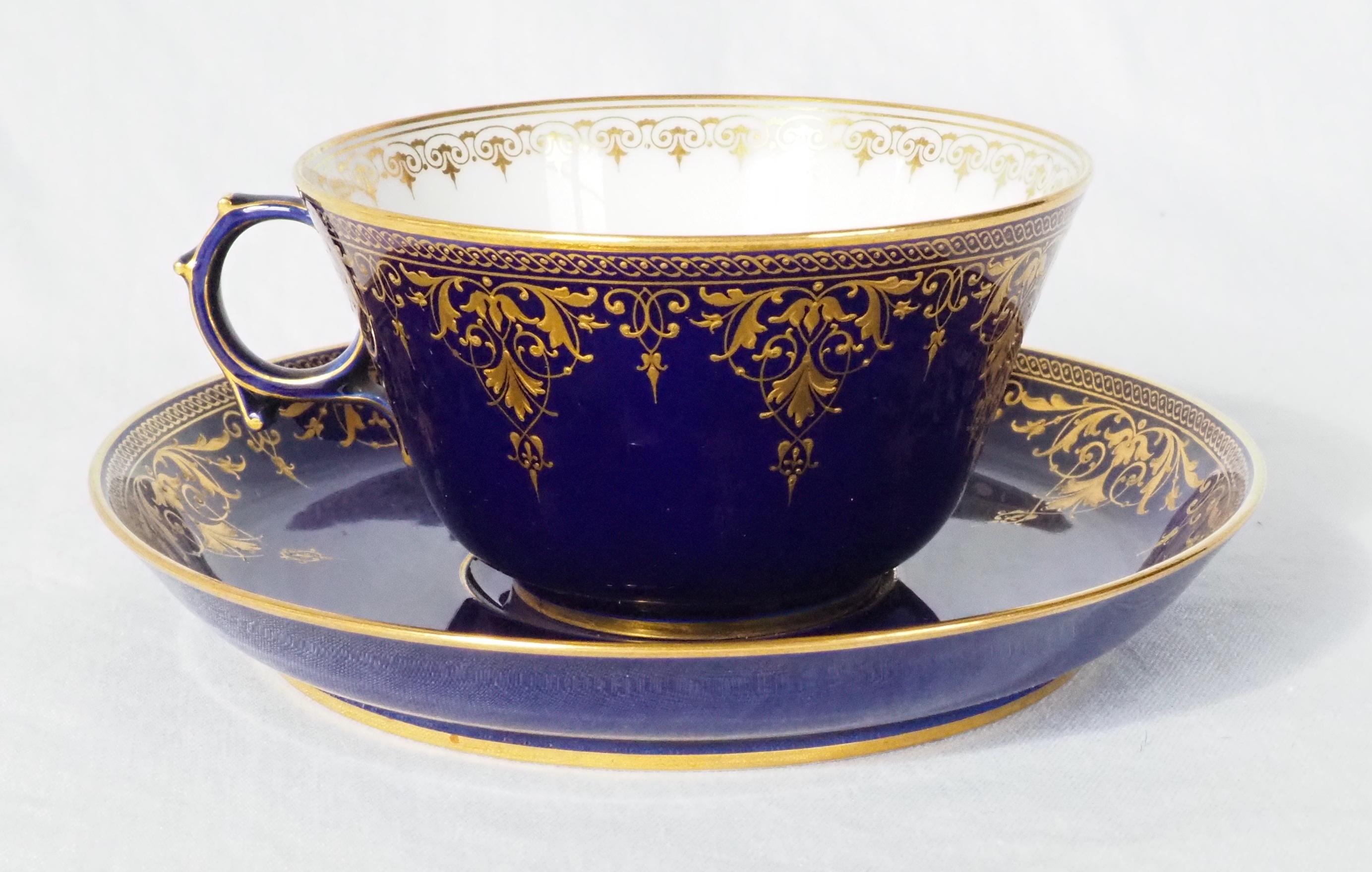 Beautiful porcelain tea cup / large coffee cup and its saucer by Manufacture Nationale de Serves.

Both pieces are decorated with fine gold Louis XVI style gilt patterns - friezes, acanthus, lambrequins - on a so-called 