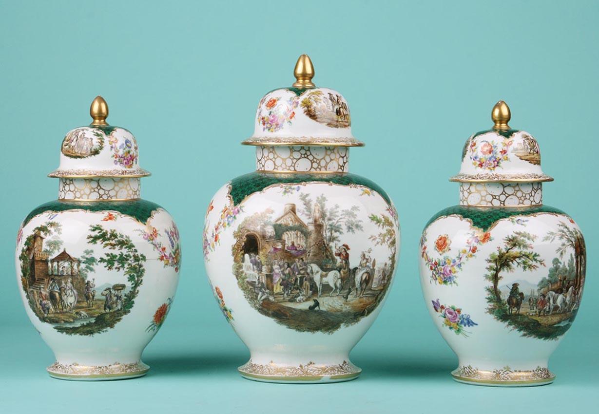 Set of three porcelain vases, painted with romantic scenes and floral motifs.
The gold paint decoration has some wear here and there, appropriate to the age. The photos give a good impression of this.
The vases are marked on the bottom with the