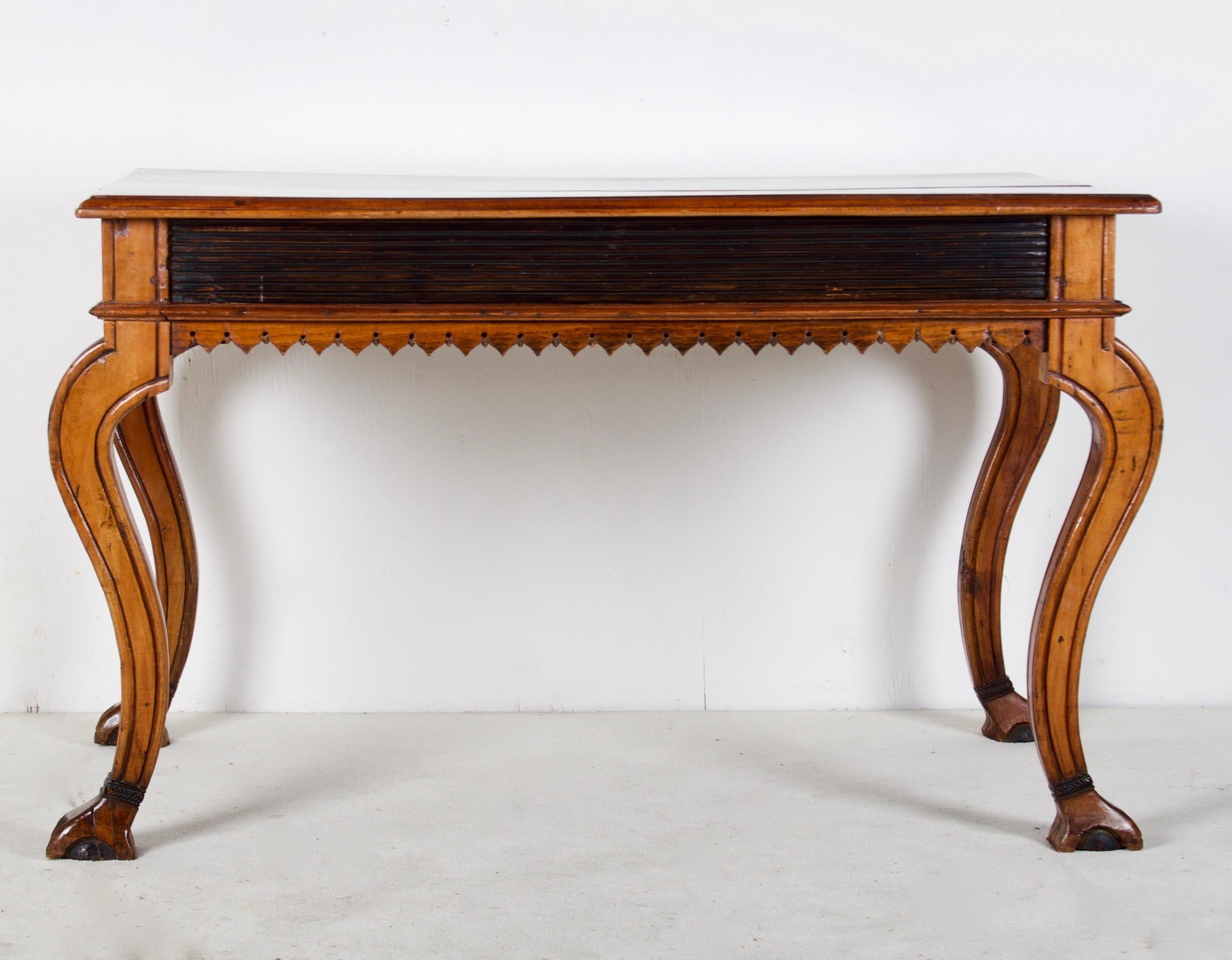 This playful and stylish desk comes from Portugal or Brazil. During
the later 19th century, both countries shared a desire for funishings
that reflect the style of the 18th Century re-interpreted. The new
Colonial style encompasses elements from