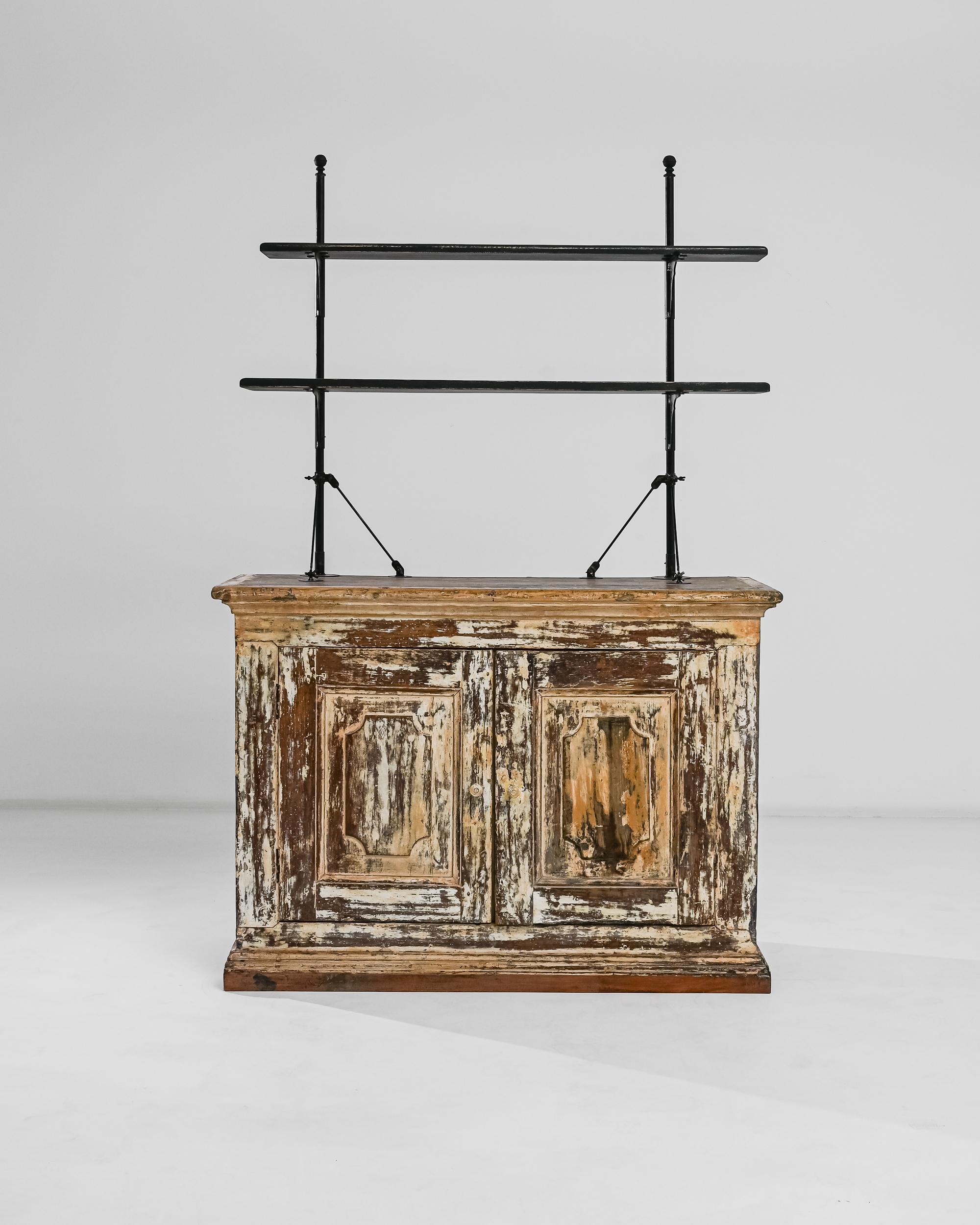 A 19th century wooden display cabinet from Portugal, this actualized cabinet is composed of two aerial shelves balanced on a double door country buffet. The structure allies the modernity of metal to the fine craftsmanship of the wood for an