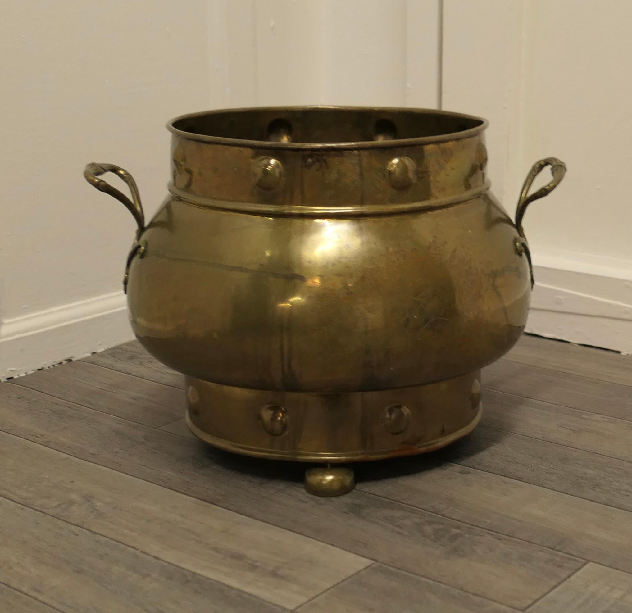 19th century pot belly brass coal bucket on feet

This is a lovely big beaten copper coal or log bucket, it has a good rounded shape with large roundels in the gothic style and would make a really good coal or log container and handy because it