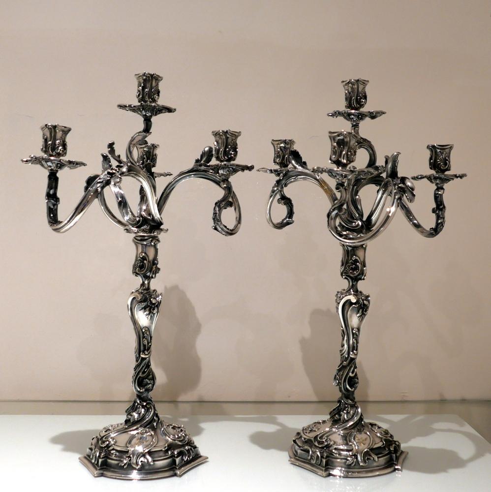 An incredibly important looking and exceptional quality pair of four light “Rococo” style French made candelabra decorated with elegant floral and foliate designs. The detachable bases have stylish contemporary engraved crests for importance.

