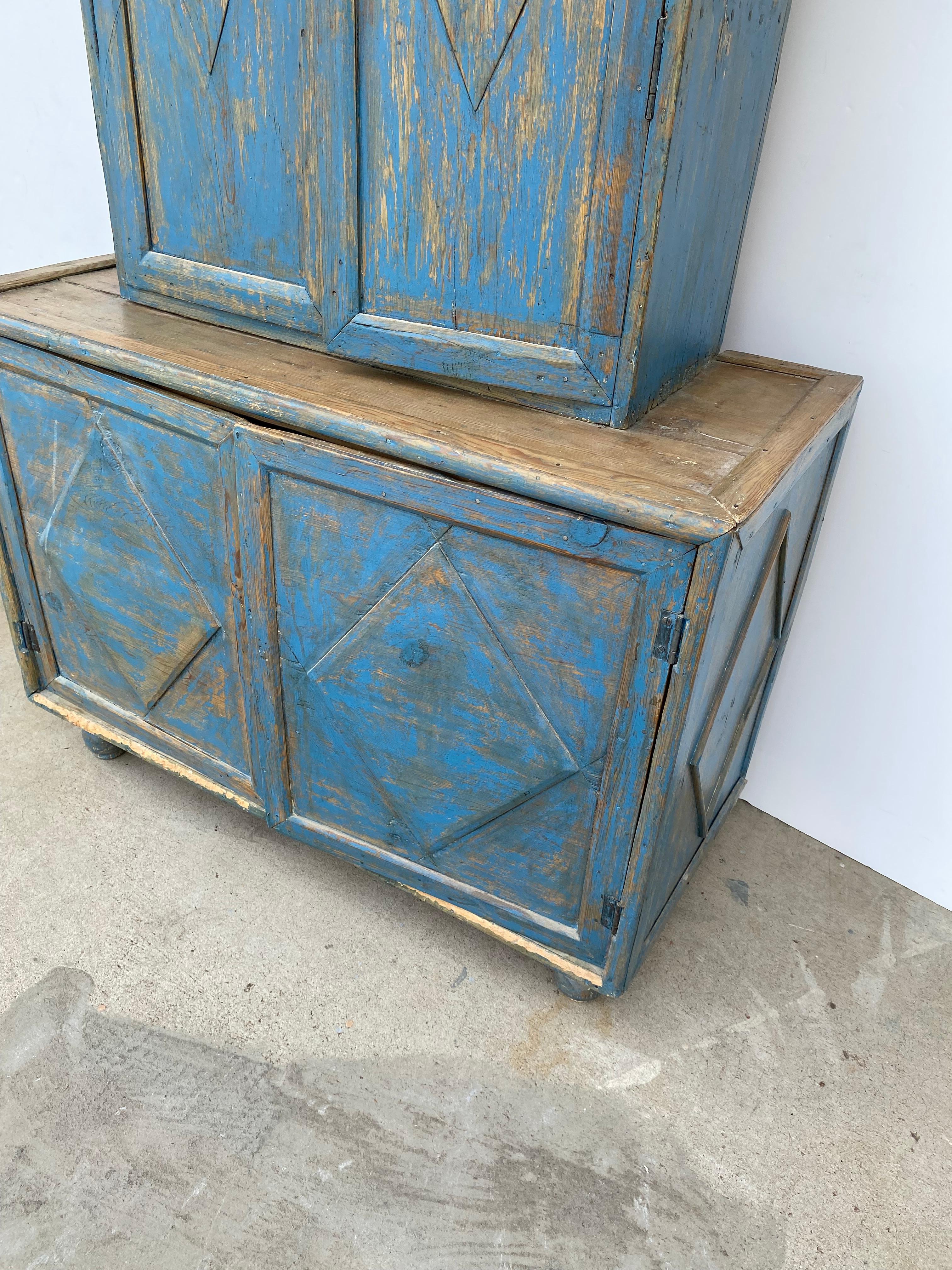 19th-century painted primitive cabinet. The top has two doors with a single shelf bottom part has two doors with no shelf.