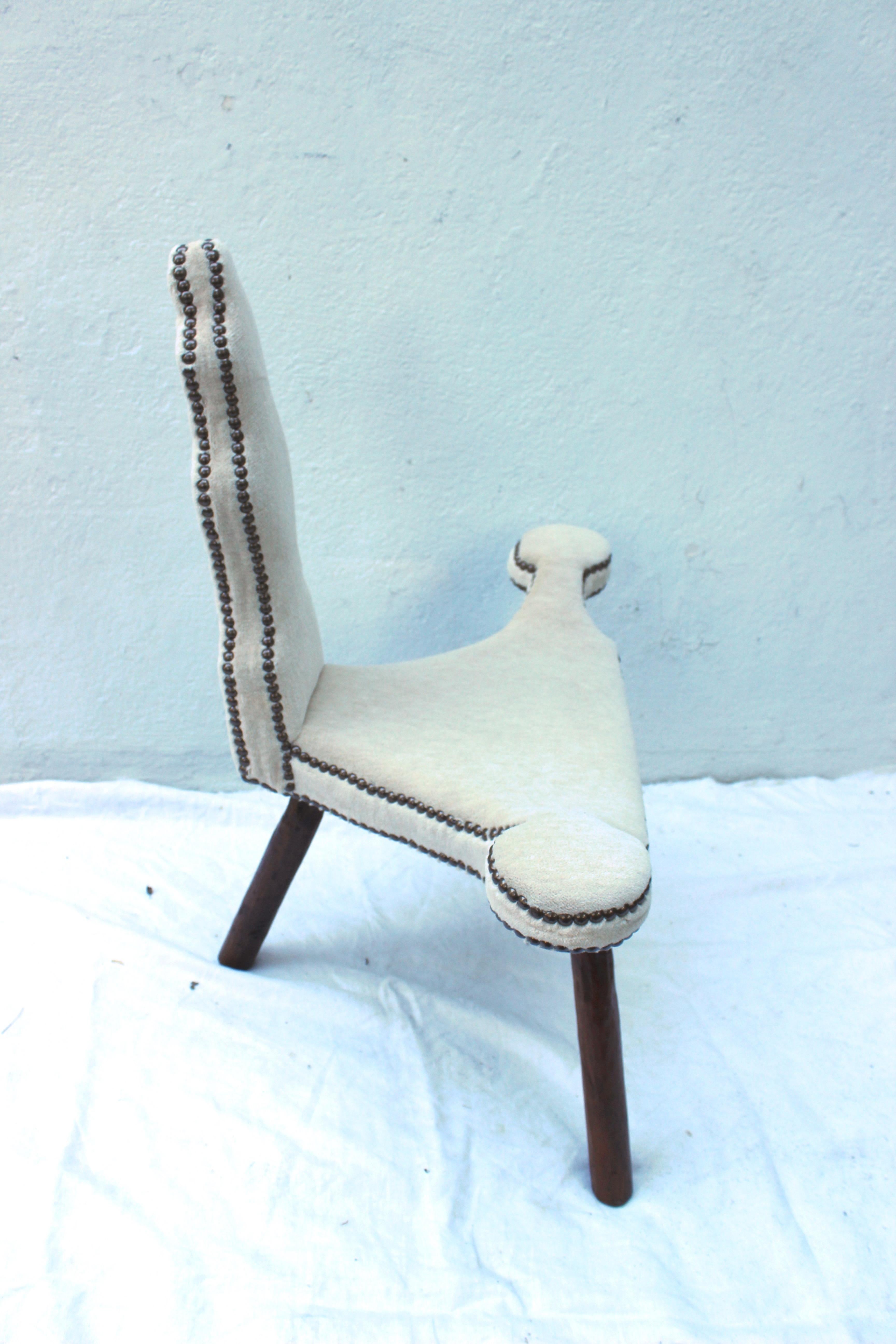 19th century Primitive three-legged wood chair newly upholstered in Alpaca velvet with bronze nailheads.