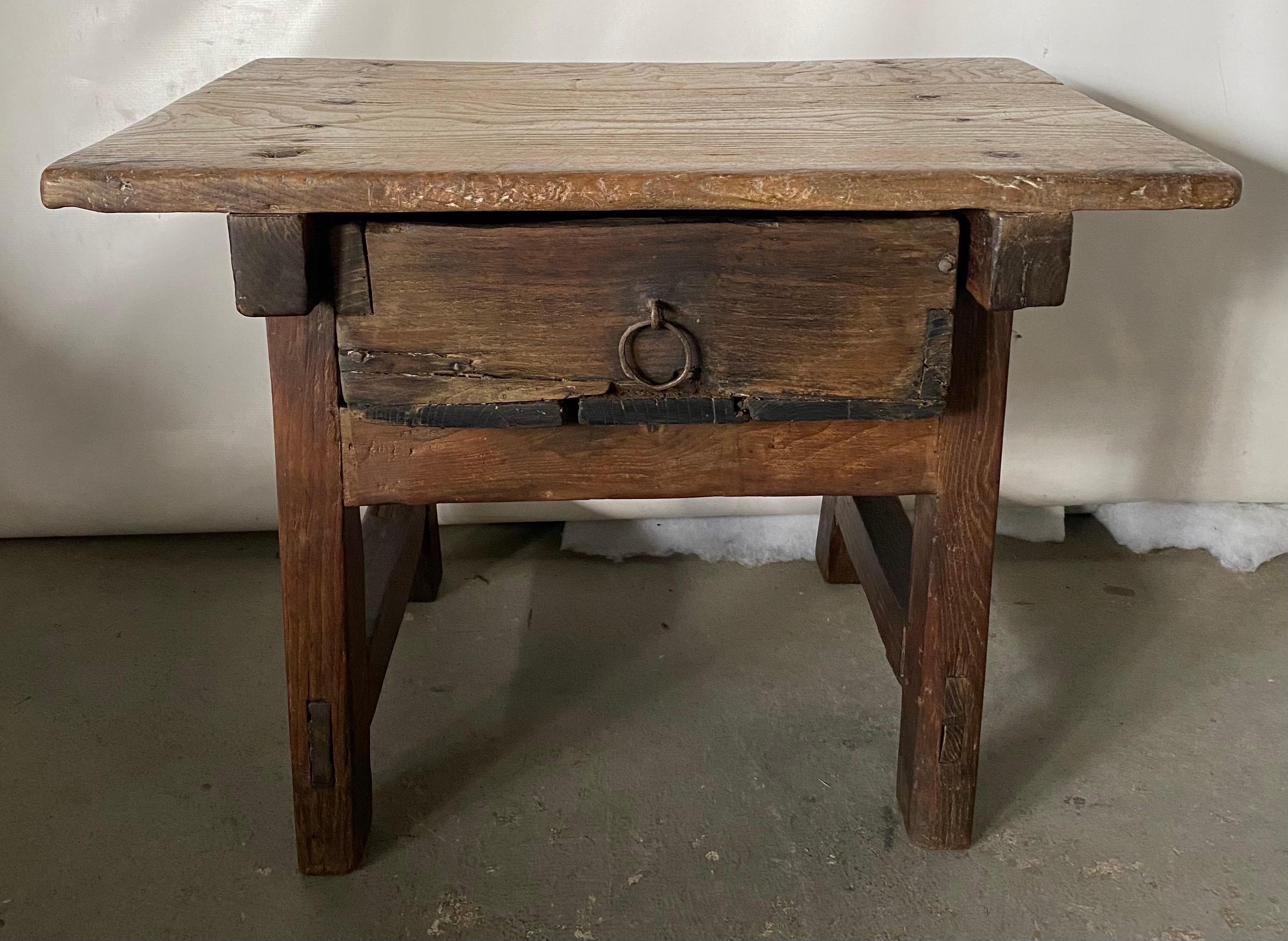19th century low rustic country single drawer side or work table. Table has wonderful aged patina. It can be used as an end table or coffee table in a rustic decoration but also it could be the used as an accent combined with midcentury pieces in a