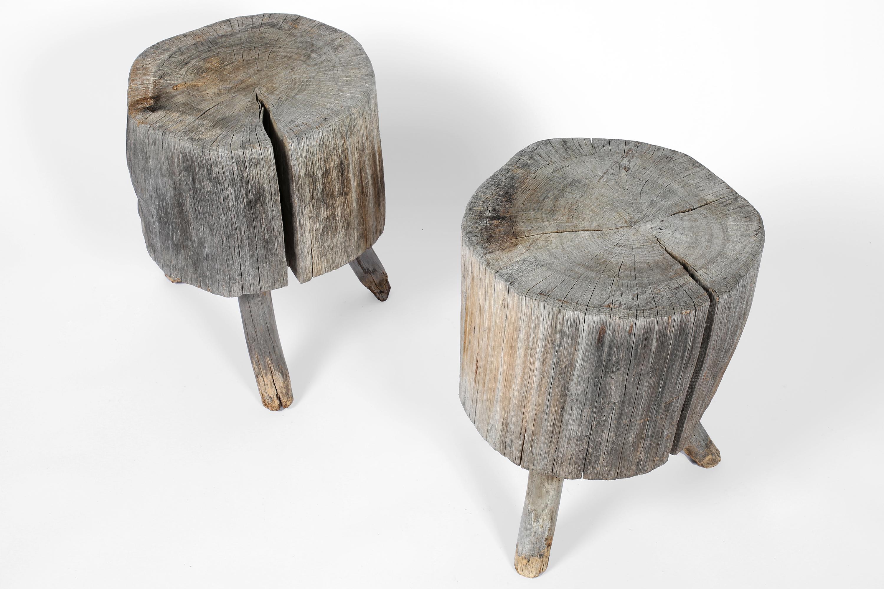 A scarce matching pair of 19th century chopping block side tables on their original tripod legs. Constructed from thick blocks of elm which have beautifully weathered to a grey patina. French, c. 1860.