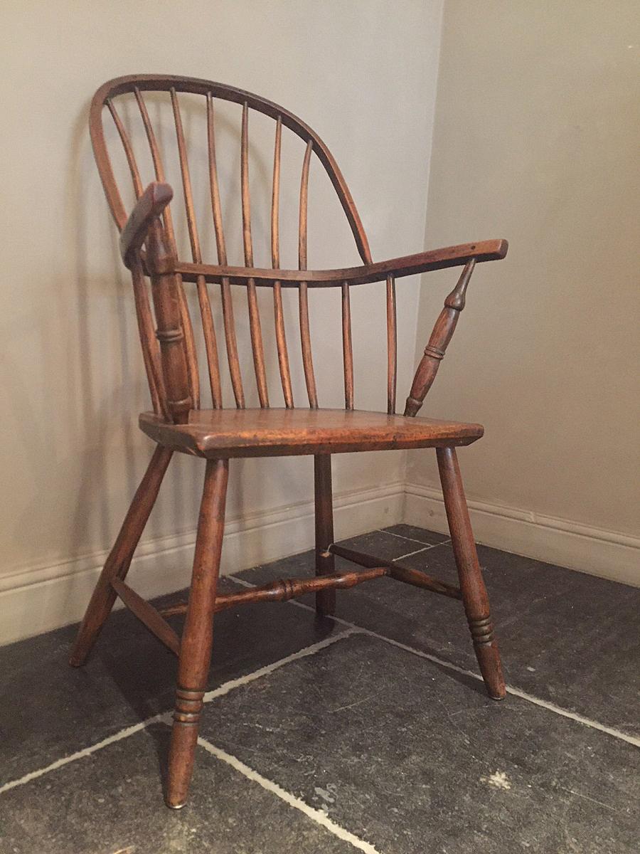 Primitive Windsor Hoopback armchair from ash and elm. Beautiful grain and patina throughout. Restored without new additions and perfectly usable.