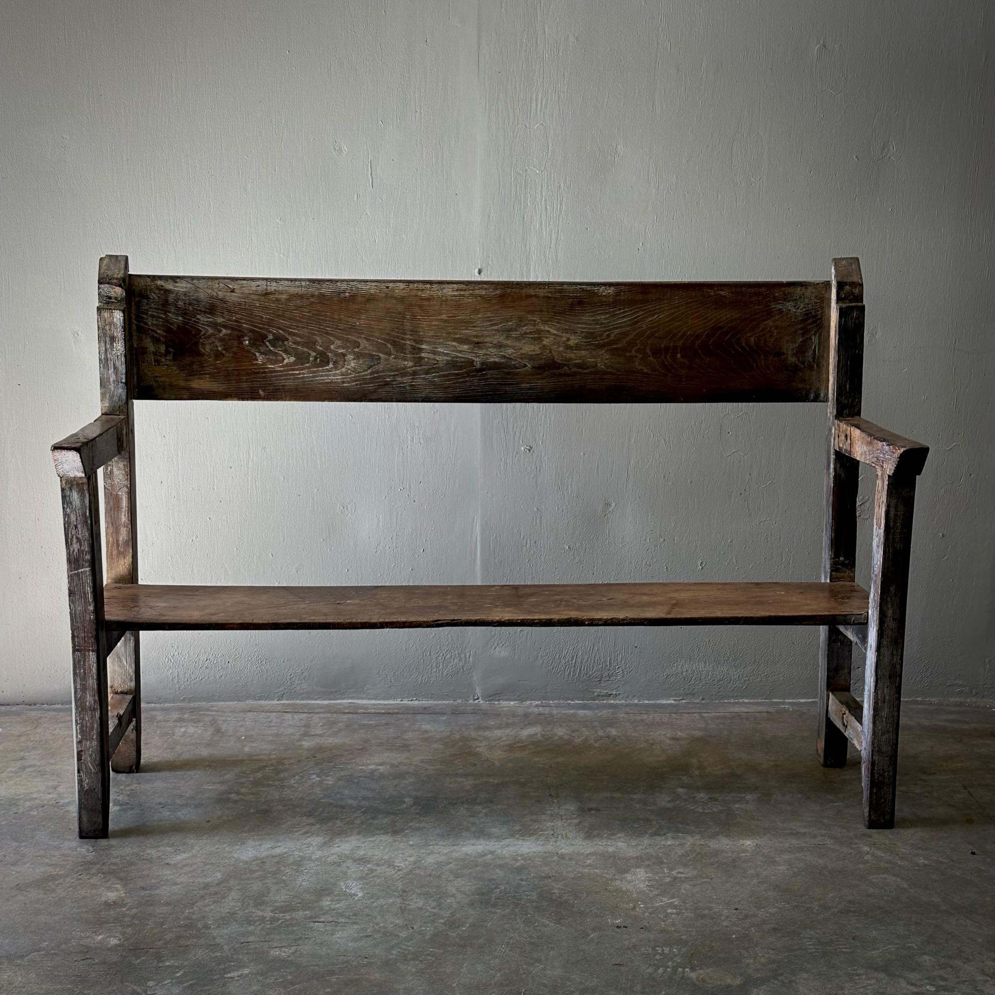 Spanish 19th Century primitive wood bench with wonderful rustic patina and severe, simple lines. Would work well in both indoor and outdoor spaces, or as an entryway or hallway bench. 

Spain, circa 1880

Dimensions: 18.9 W x 61.8 D x 41.3 H x