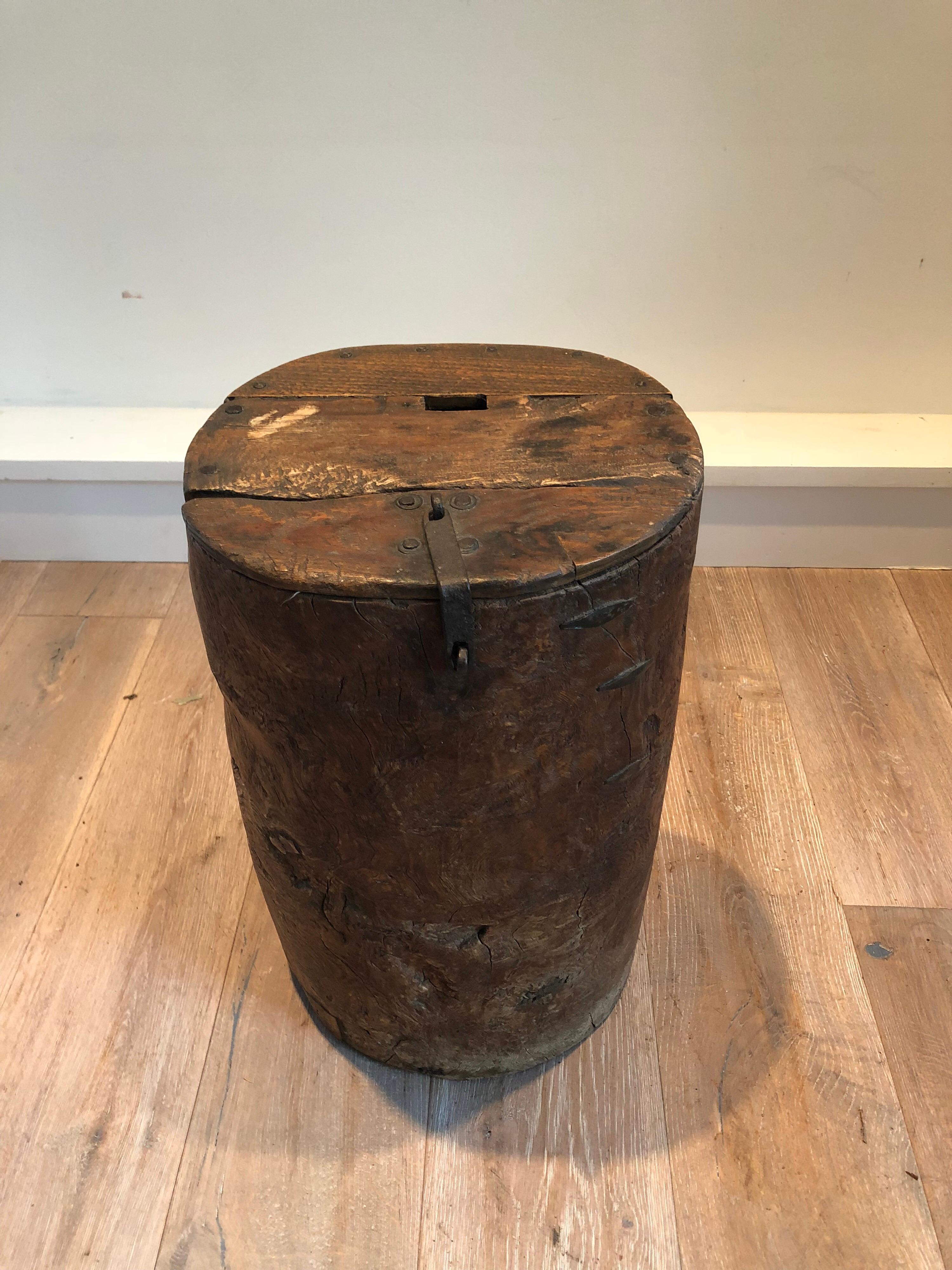 A unique 19th century Primitive wood drum table. Excellent hand carved drum with iron rivets and container hinges.