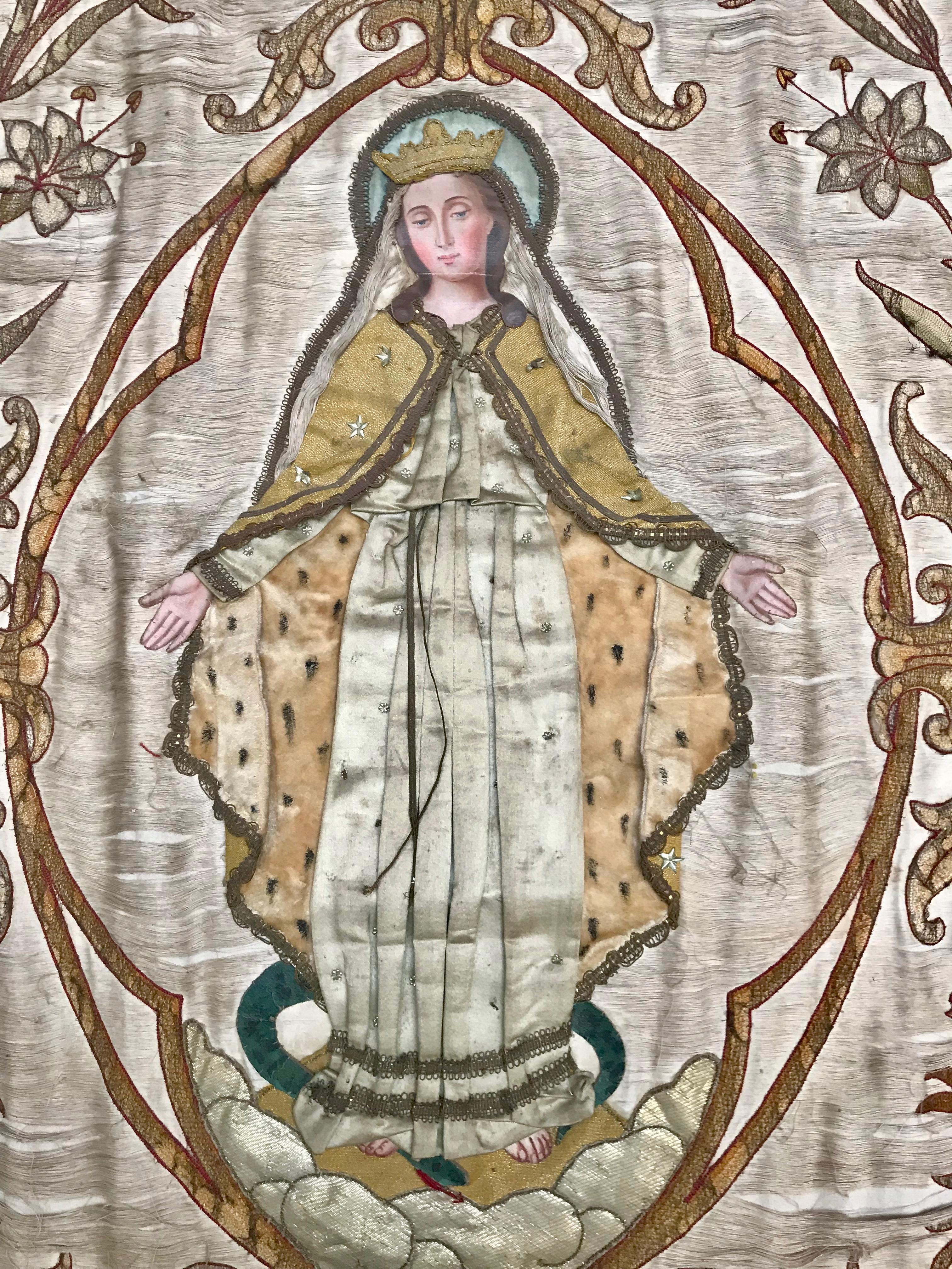 This French processional banner has been created in a layered applique manner with details such as tiny silver stars attached by hand.
The face, hands and feet are expertly hand-painted on canvas and lend a most interesting dimension to the overall