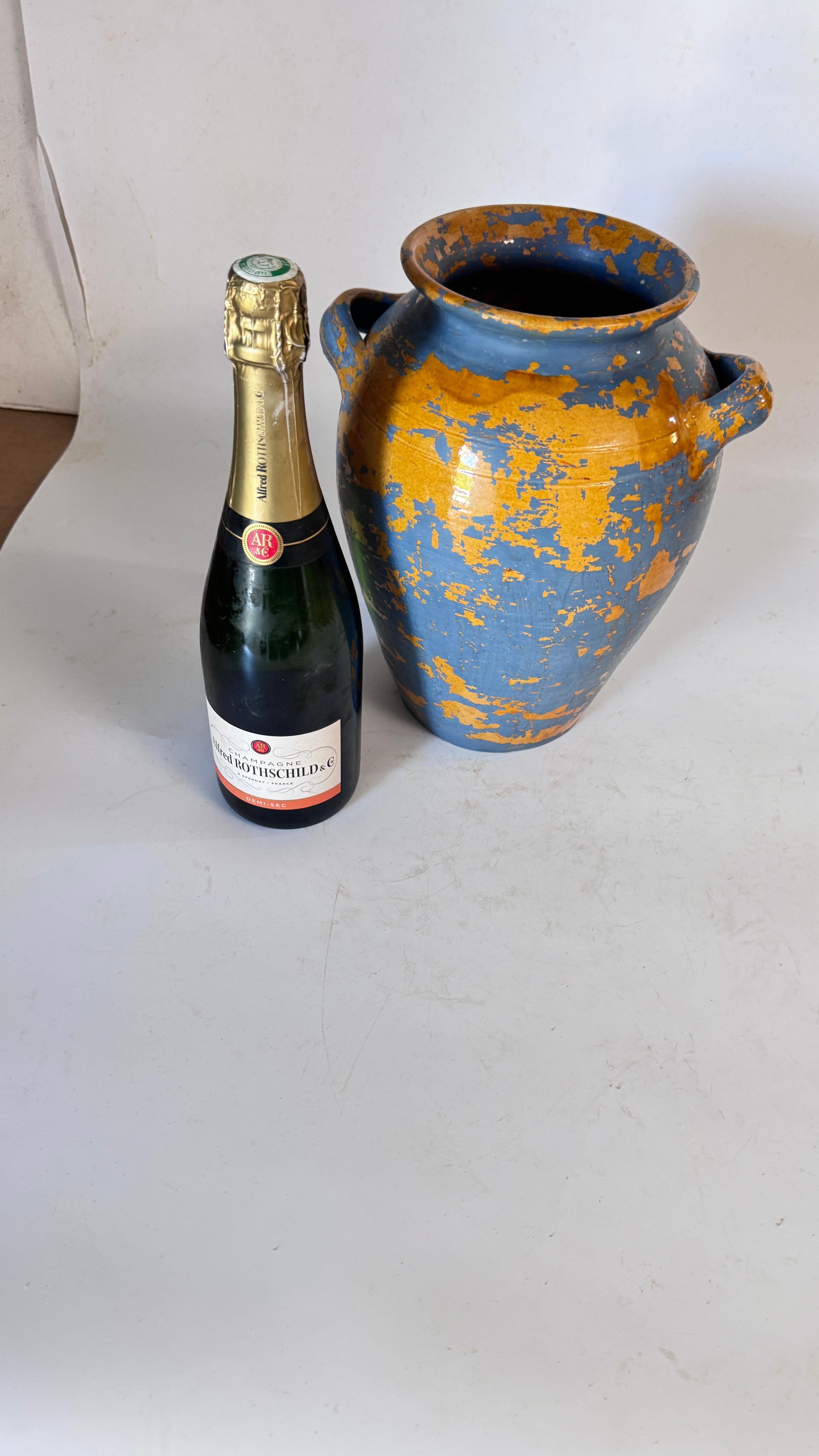 Si tratta di un vaso in terracotta del XIX secolo proveniente dalla Provenza, originariamente smaltato in giallo solare e successivamente arricchito da una patina blu decorativa. Il risultato è un oggetto sorprendente e altamente decorativo, che