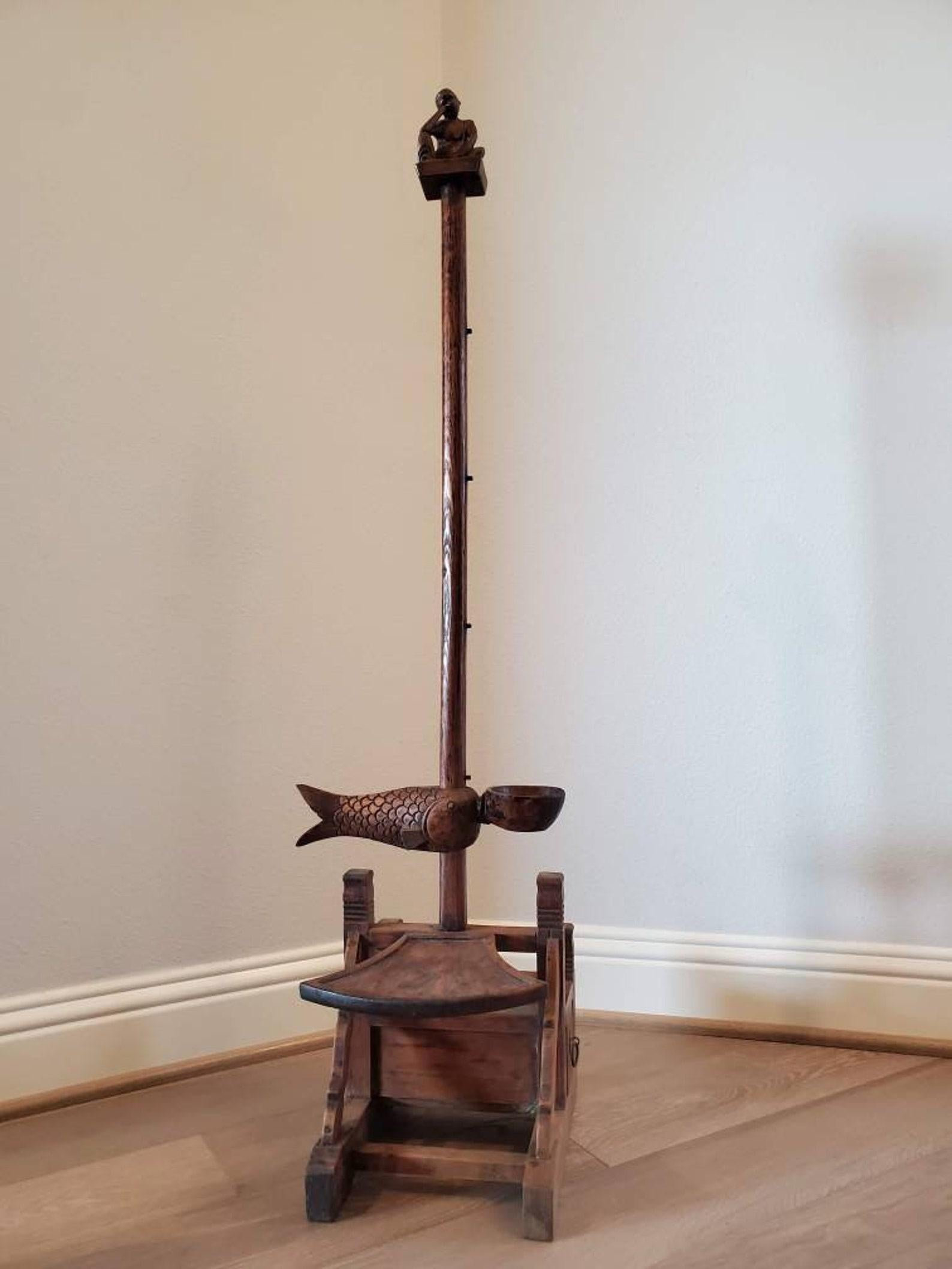 A scarce antique Chinese carved hardwood, most likely elm, adjustable candlestick stand floor torchère with beautifully aged warm rich patina.

Candle floor lamps such as this were used up through the 19th century before the advent of electricity,