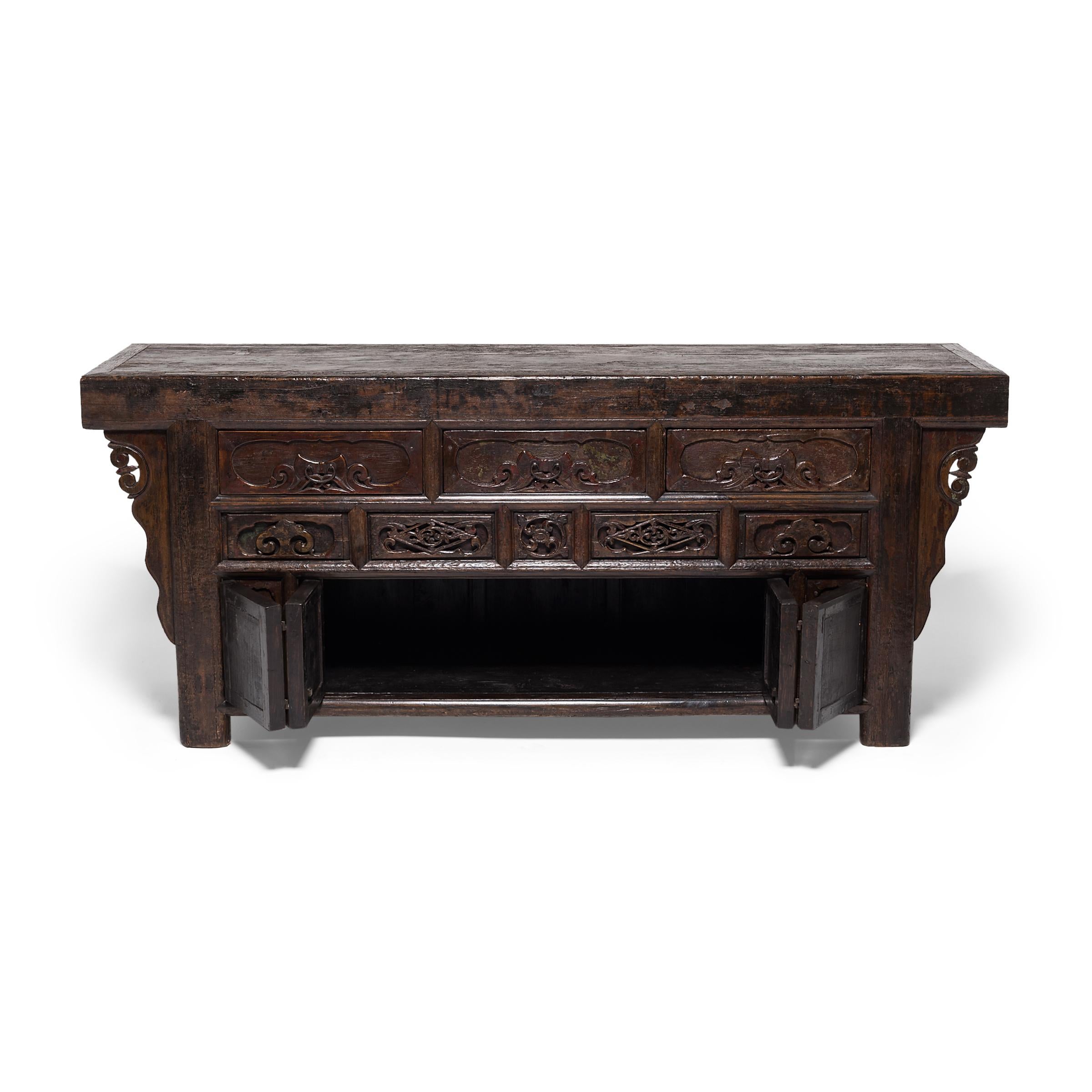 The grand scale of this 19th-century coffer suggests it was originally used in a Qing-dynasty home as a family altar. Incense, candles, and fruits would have covered the cabinet top as offerings to the family's ancestors. Such items were stored in