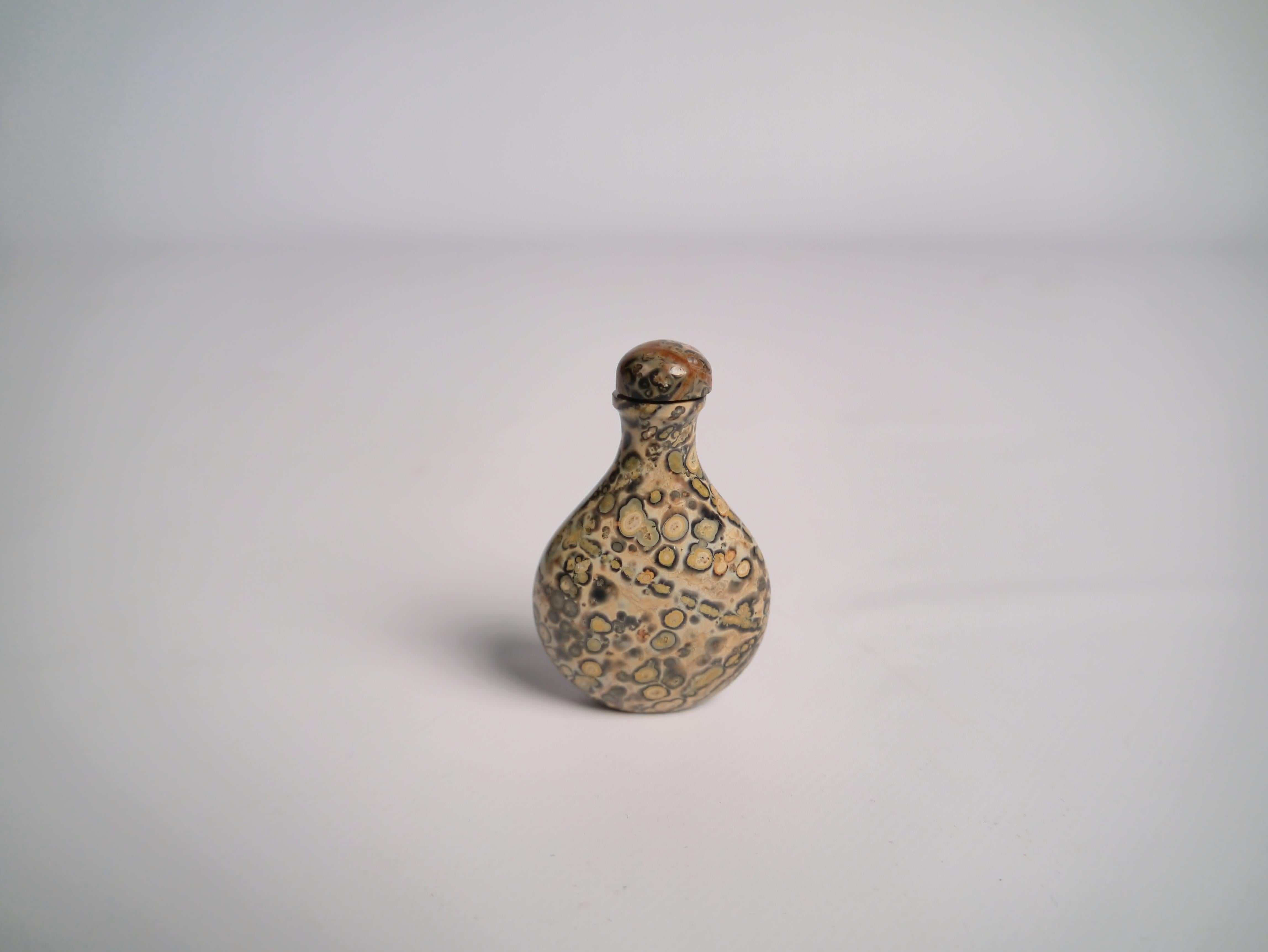 19th century Chinese snuff bottle. Hand carved in a richly marbled puddingstone. Both bottle and tap made of same material.