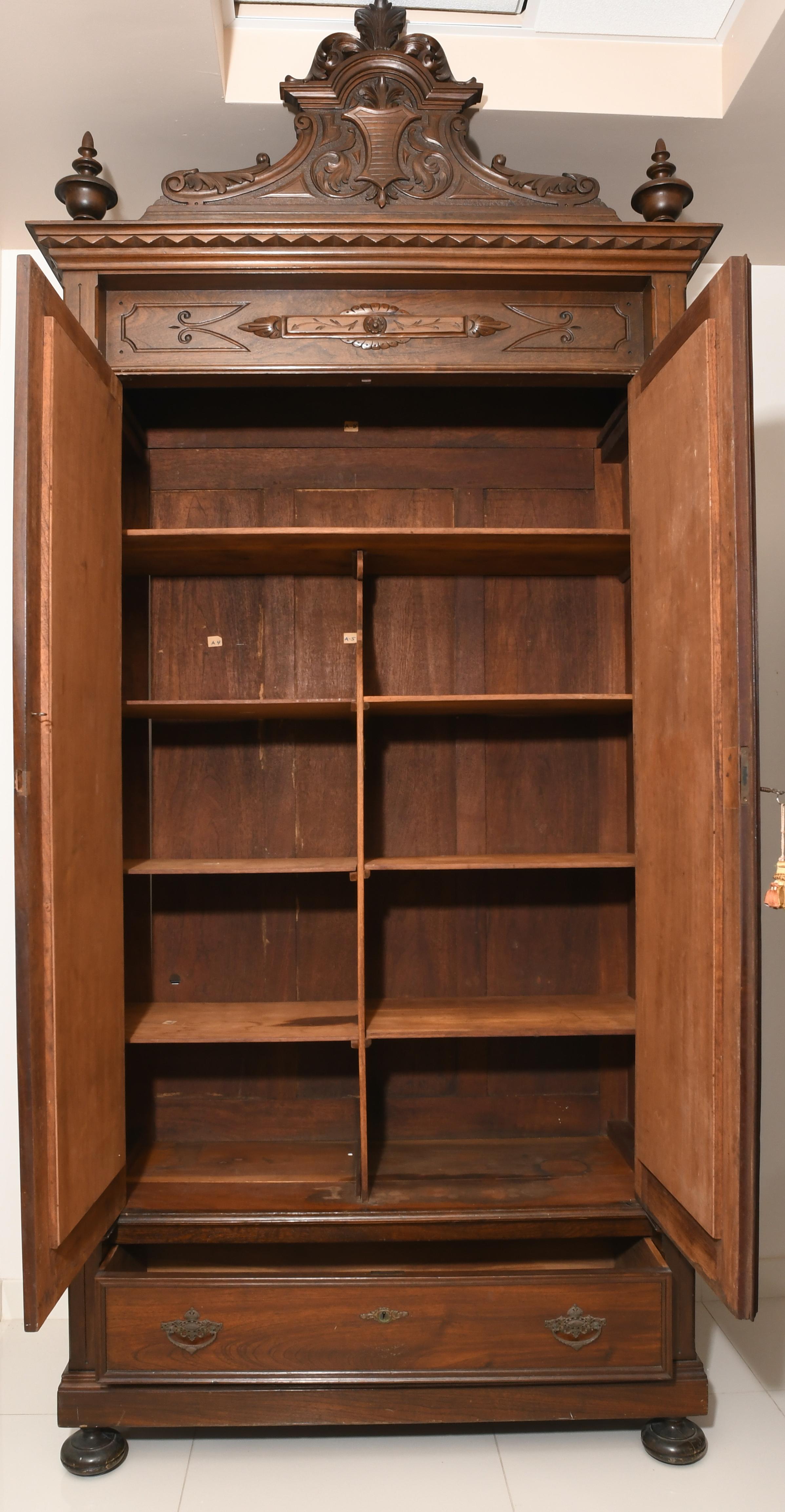 Dresser/Armoire from the Puerto Rican cabinetmaker Rafael Margarida who established his workshop in Old San Juan since 1892. The pediment has two inverted arcs that join to end in a crown. The center of the pediment is adorned with a carving