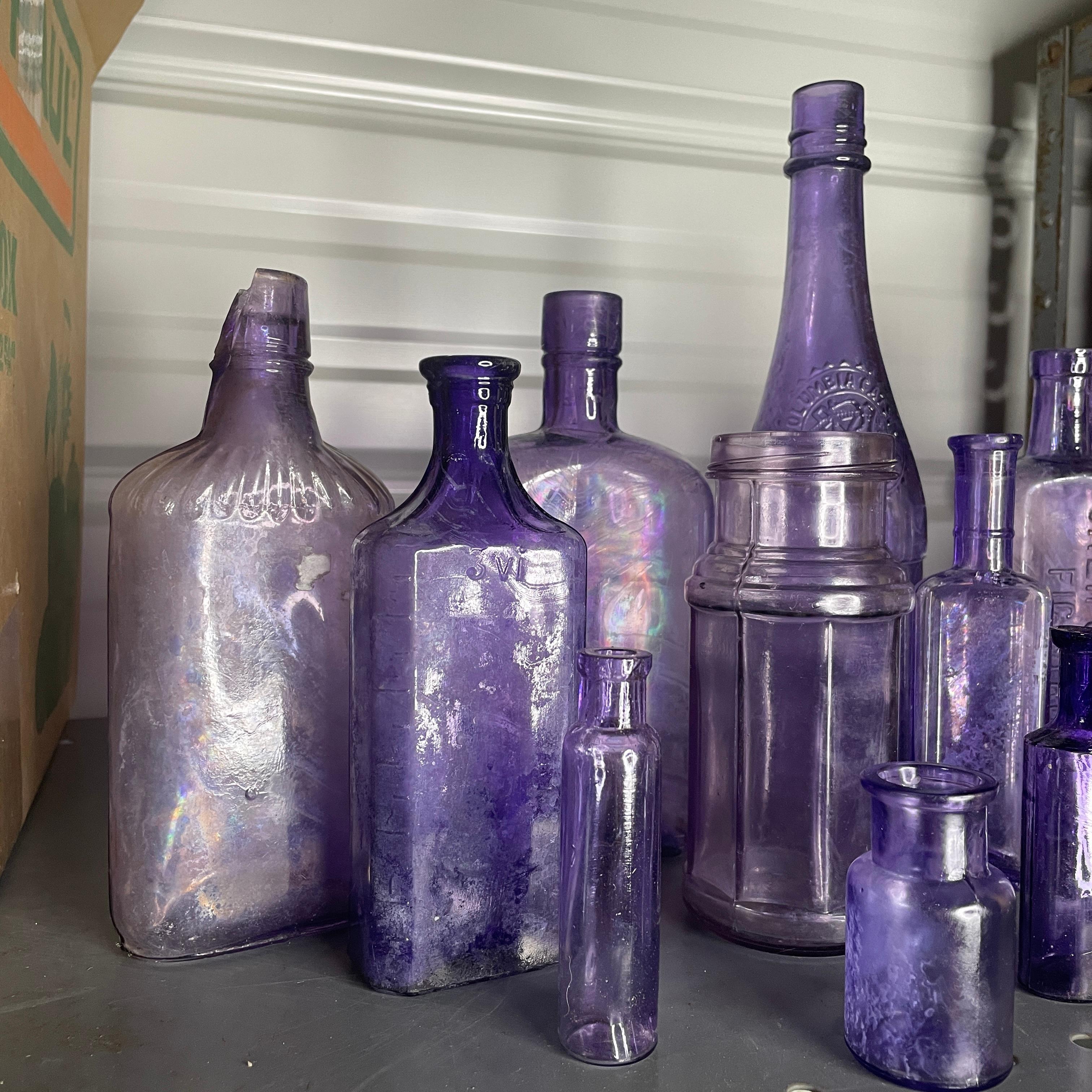This large collection of antique purple glass bottles is great for starting or adding to your bottle collection. A lot of these bottles were originally clear glass, but the glass can change color if placed into sand for a period of time. Some pieces