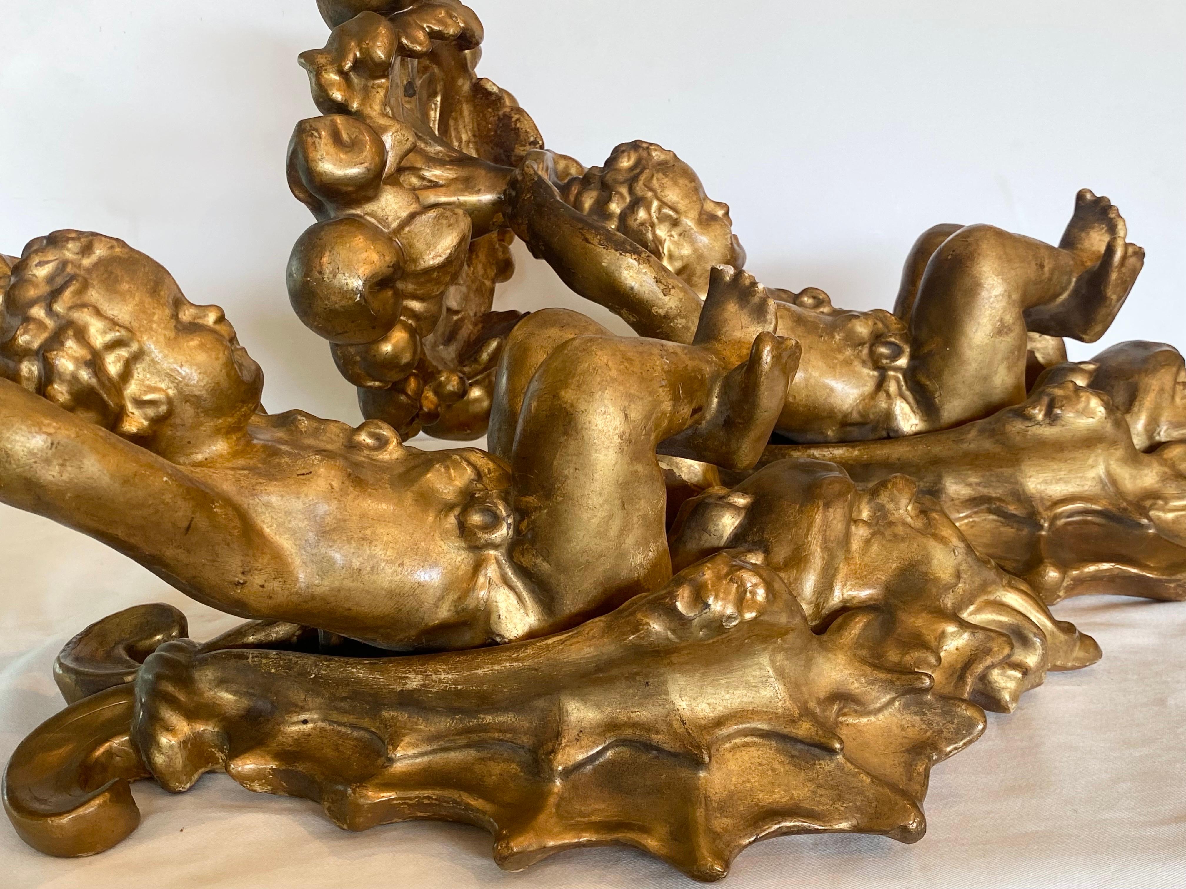 Pair of lovely Italian gilt cherub and shell carved wall brackets.... in the grotto style.