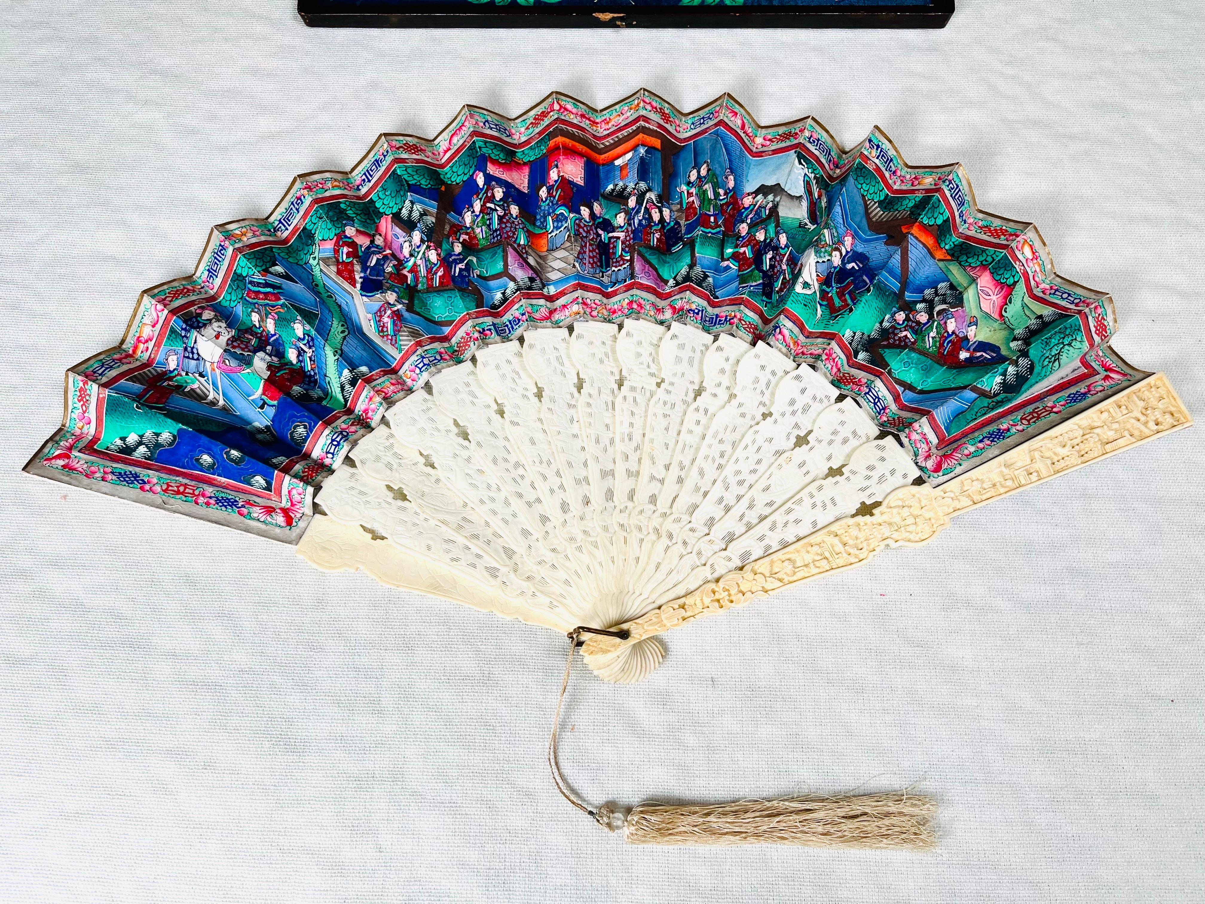 A beautiful 1800s Canton fan having highly detailed carved bone stays with a hand painted scene on each side. Included is the original storage box which features its own scenery details. In fantastic condition, in fact among the best condition