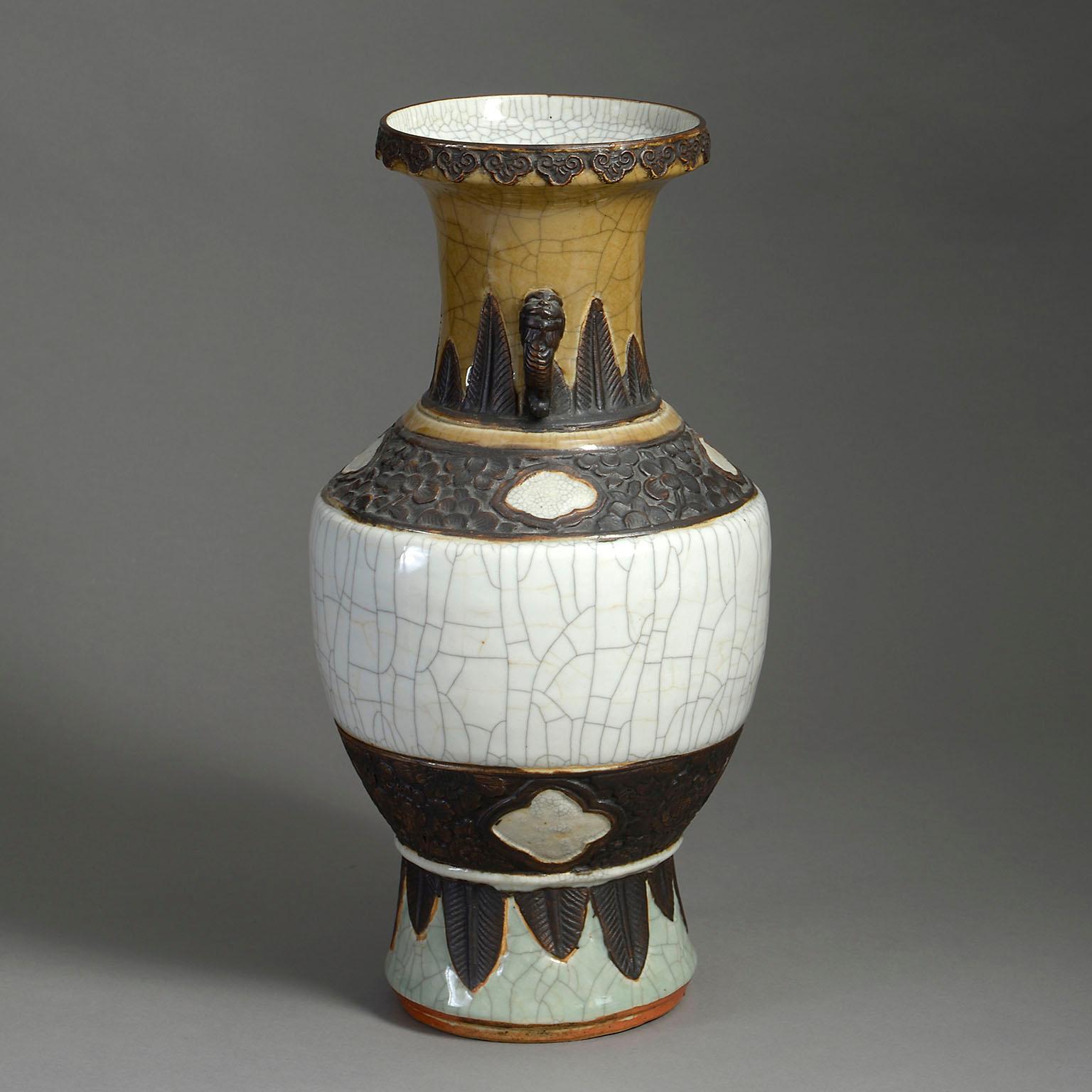 A mid-nineteenth century crackleware porcelain vase of good scale, with caramel, white and celadon glazes and applied and incised faux bronze decoration throughout.

Circa 1860 China

Dimensions: 9 W x 9 D x 17 H inches
23 W x 23 D x 43 H cm