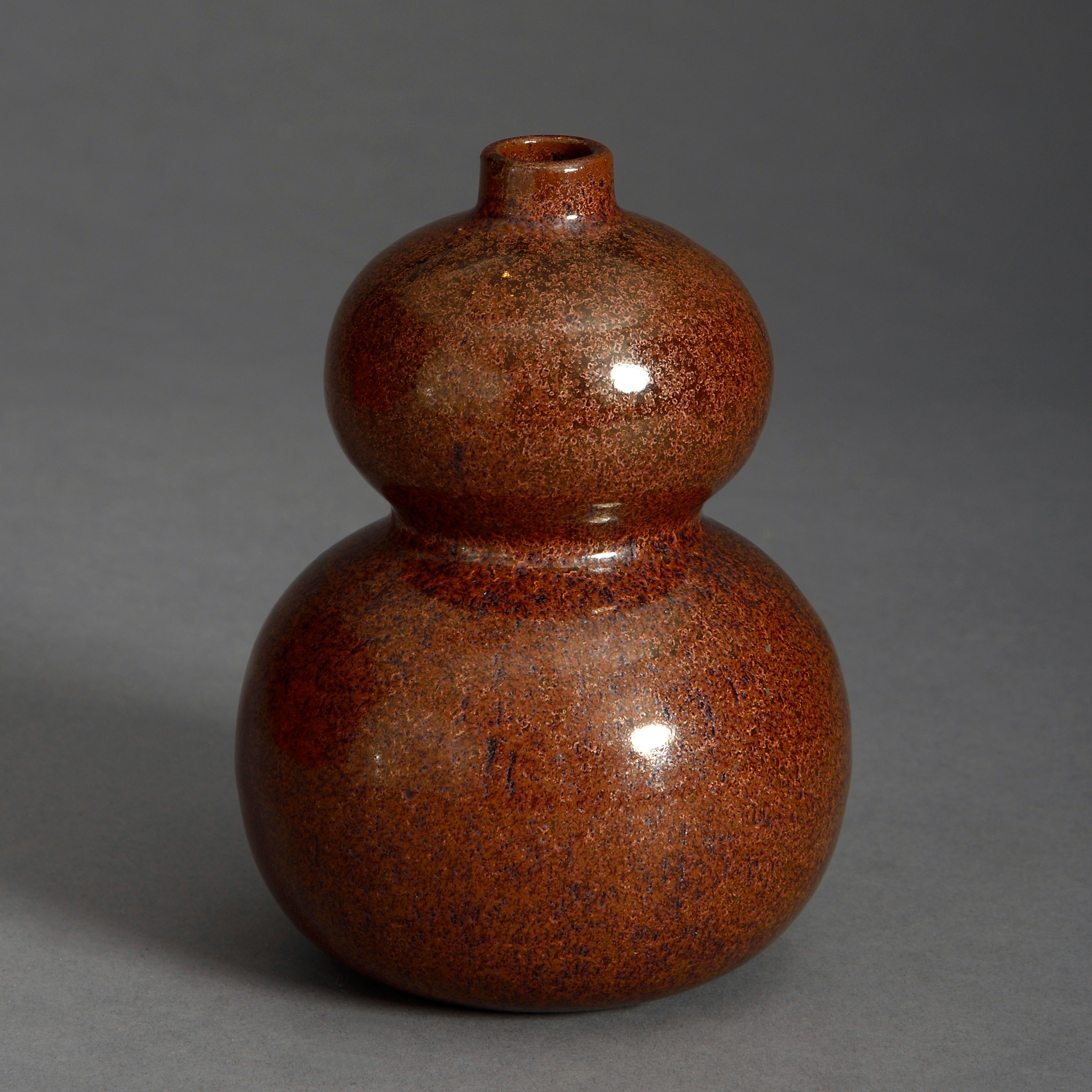 A small scale mid-19th century tea dust glazed vase of gourd form.

Late Qing dynasty.

    
