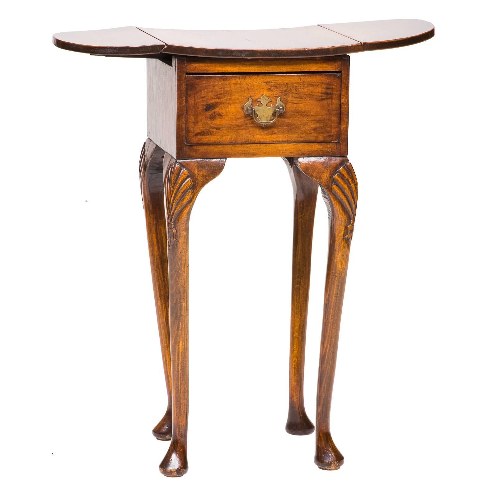 19th century Queen Anne walnut and burl walnut side table with drop leaves and leaf supports. There is one drawer (functional). The top is designed with a slight concave feature. Four cabriole legs with shell carved knees and ending with pad feet.