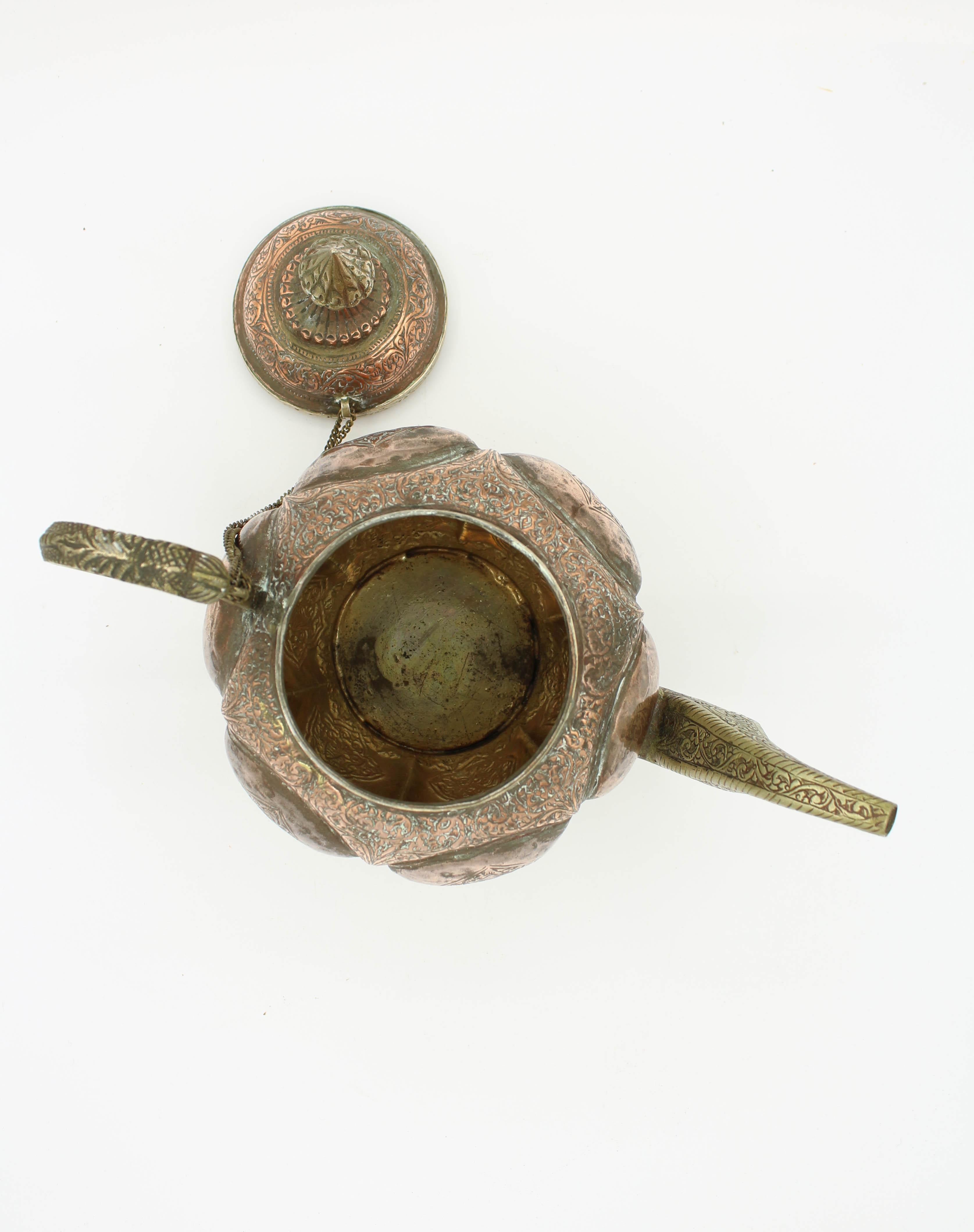 A copper and silver Indian 4-piece tea and coffee service, 3 pots and covered sugar. Dragons cavort over handles and surfaces. 19th Century Raj period. Kashmir region 9