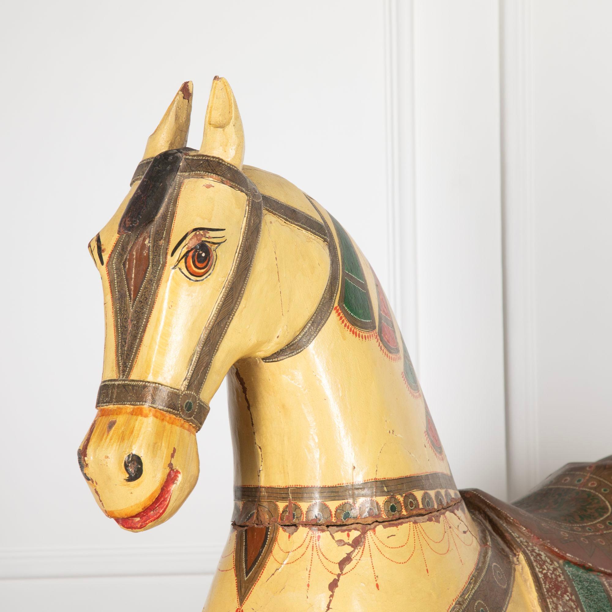 19th Century Rajasthani wedding horse.
In carved wood and elaborately painted decoration to the saddle - a model of a white mare or 'ghodi'.