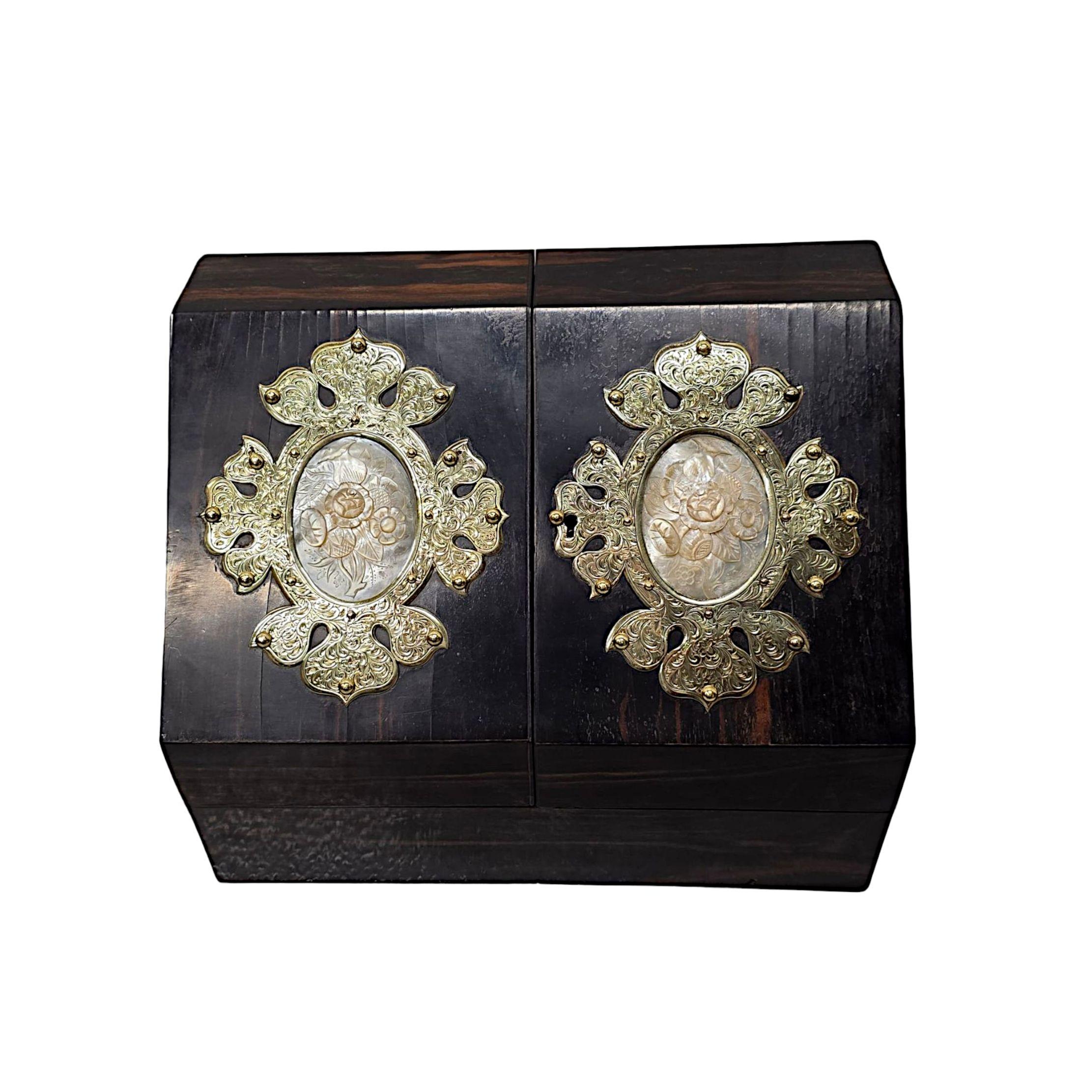 A very rare 19th Century well figured coromandel desk set of exceptional quality with rich patination and grain, finely hand carved with highly decorative studded brass mounts and stunning mother of pearl detailing throughout.  This gorgeous set is