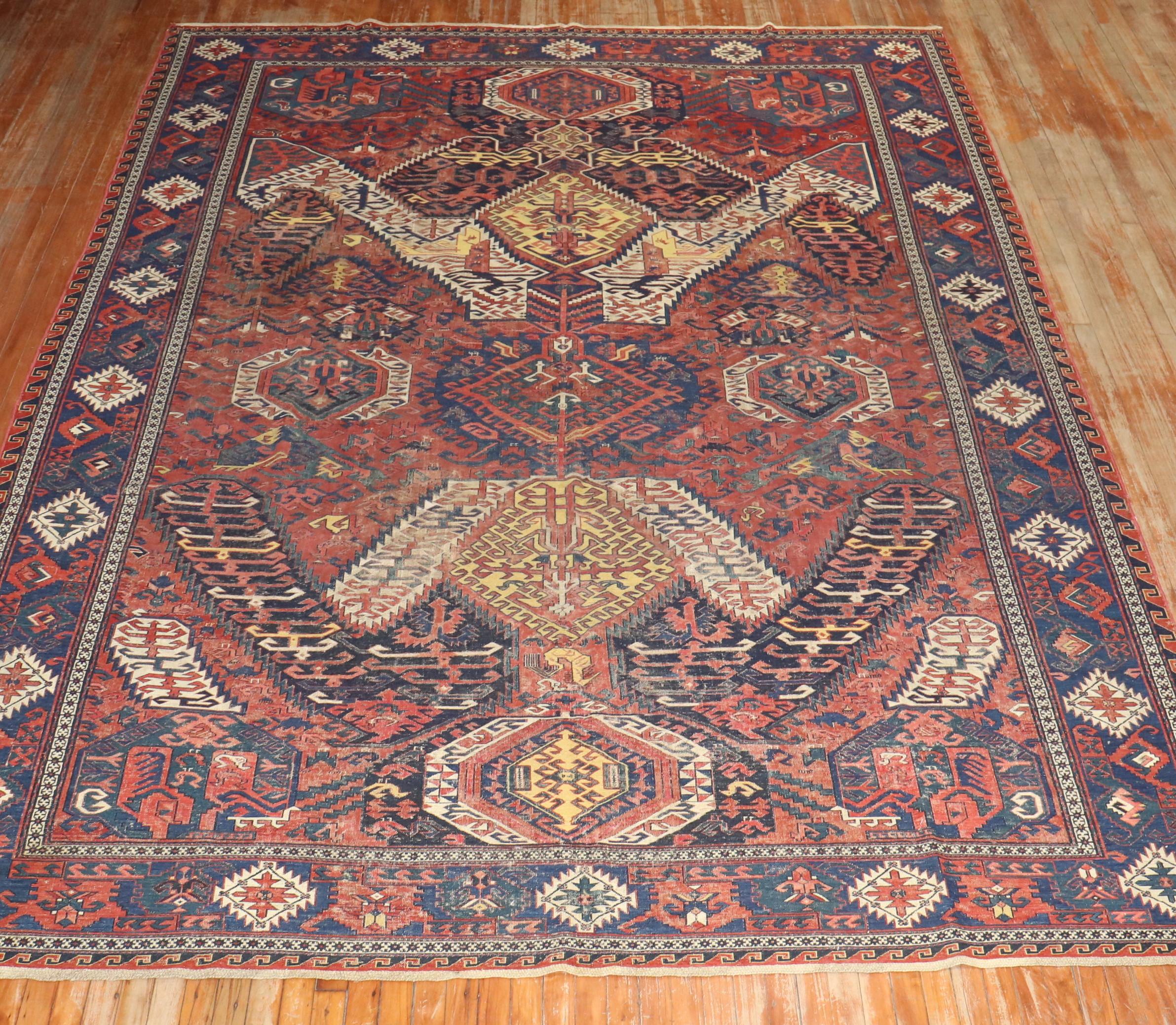 late 19th-century room size magnificent large antique Caucasian Soumak rug features a rare Dragon medallion pattern. The rust ground with contrasting green, blue, and yellow tones make this striking piece an exceptionally rare and appealing example