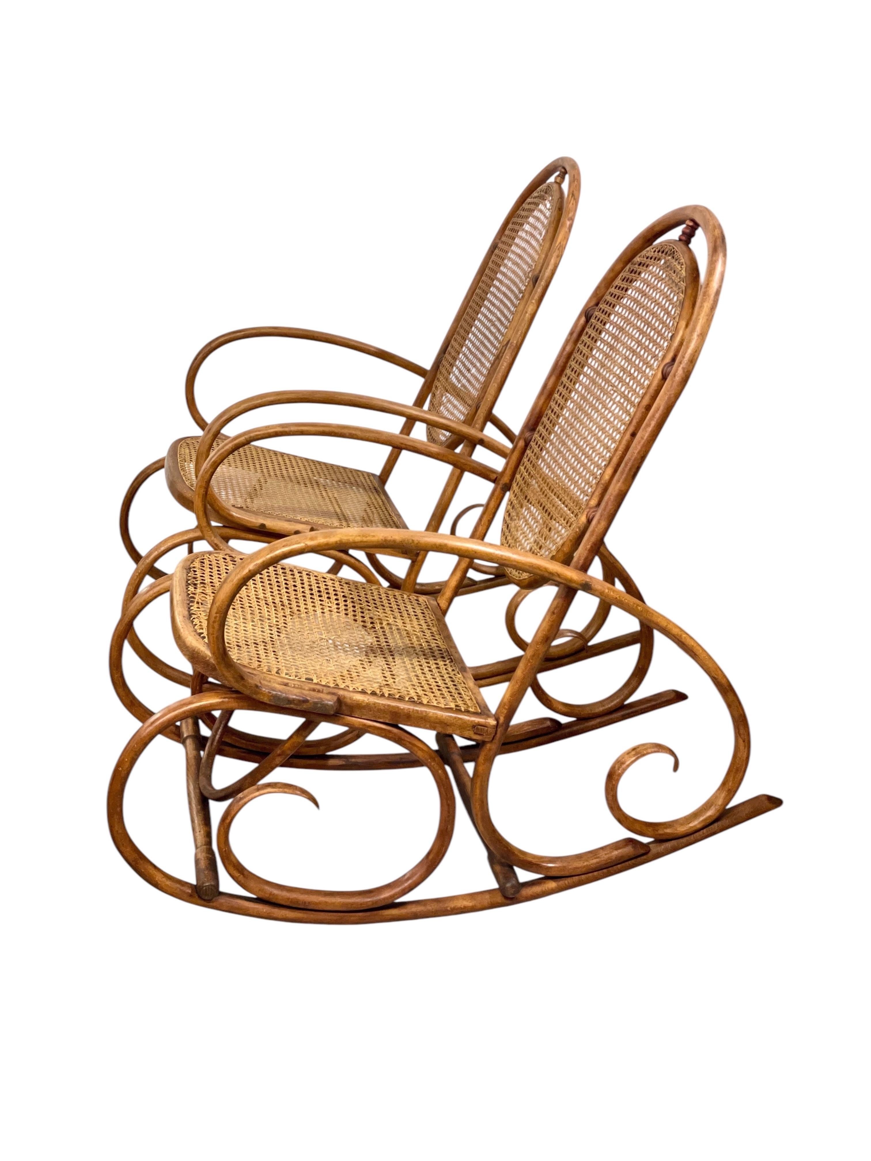 This exquisite pair of vintage rocking chairs showcases the timeless beauty of curved wood craftsmanship paired with the elegance of handwoven cane seating. Made from high-quality bentwood, these chairs boast gracefully arched frames that highlight