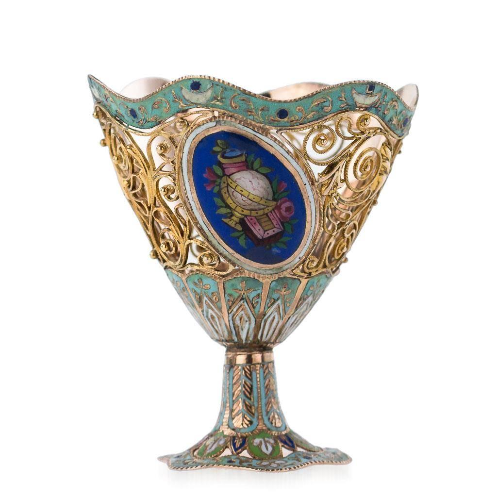 Antique early 19th century Swiss 18-karat {750} gold and enamel zarf made for the Turkish market. Vase shaped of intricate gold filigree applied with leaves and scrolls, with oval cartouches of enameled flowers and musical instruments on dark blue