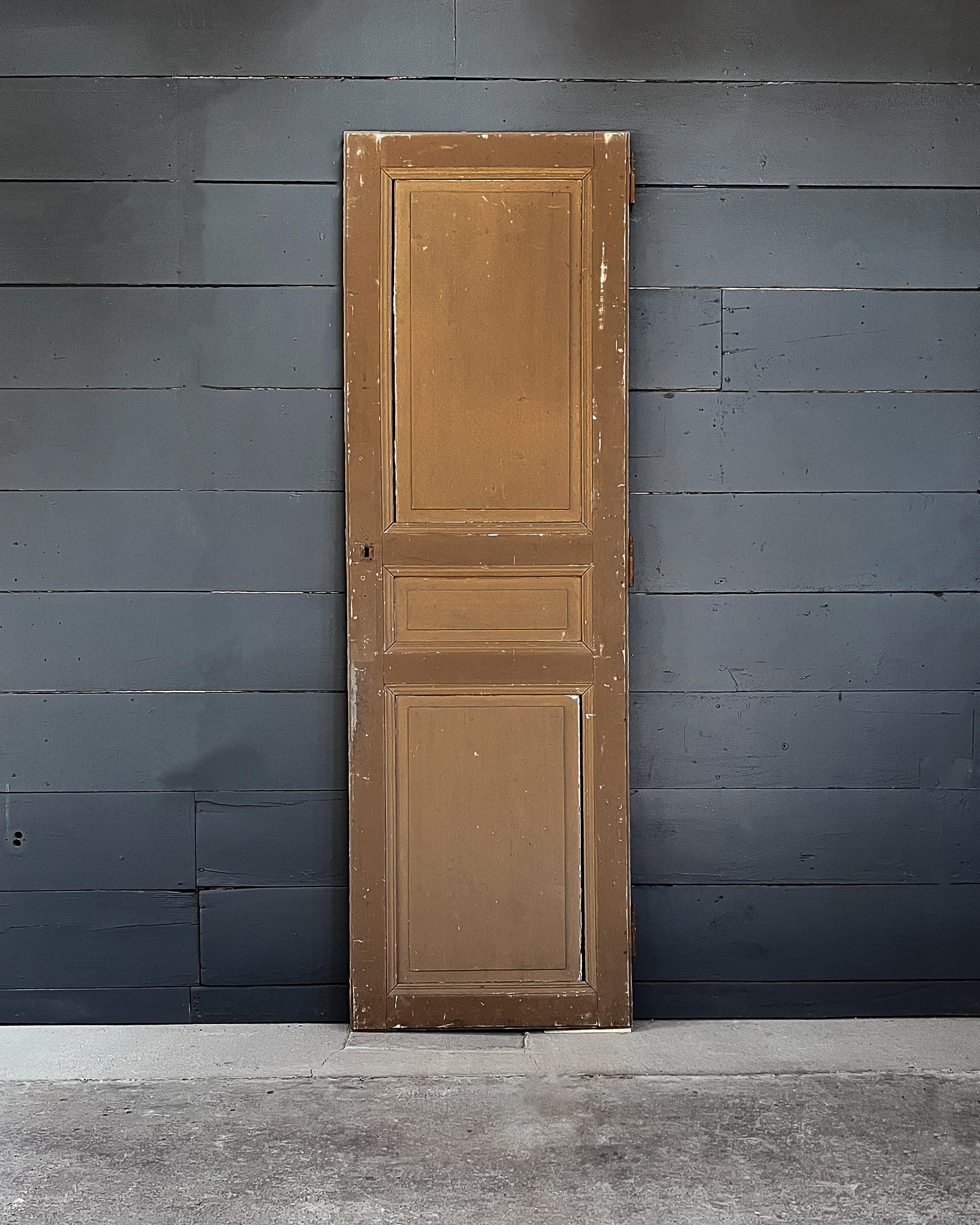 Raised 3-panel configuration wardrobe door with grooved trim. Bring the French country charm into your home when installing this door to enclose a linen cabinet or pantry.

Salvaged in France, 19th century.

The door is crafted from fir wood and is