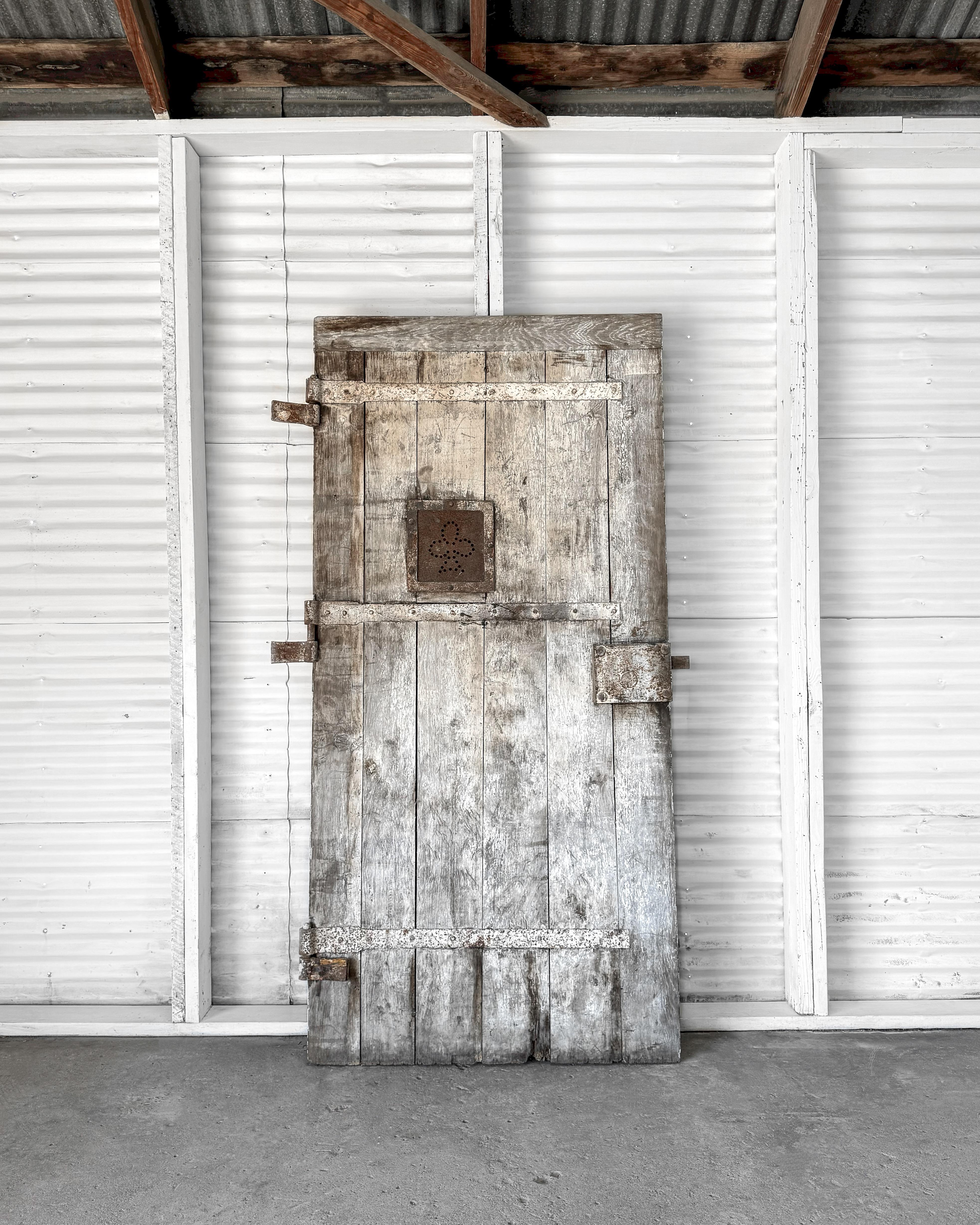 Using old salvaged doors in new modern homes adds a distinctive touch of history and character. This one-of-a-kind reclaimed door, once serving as the entrance to the courtyard of a 19th-century French countryside home is a perfect example. Crafted
