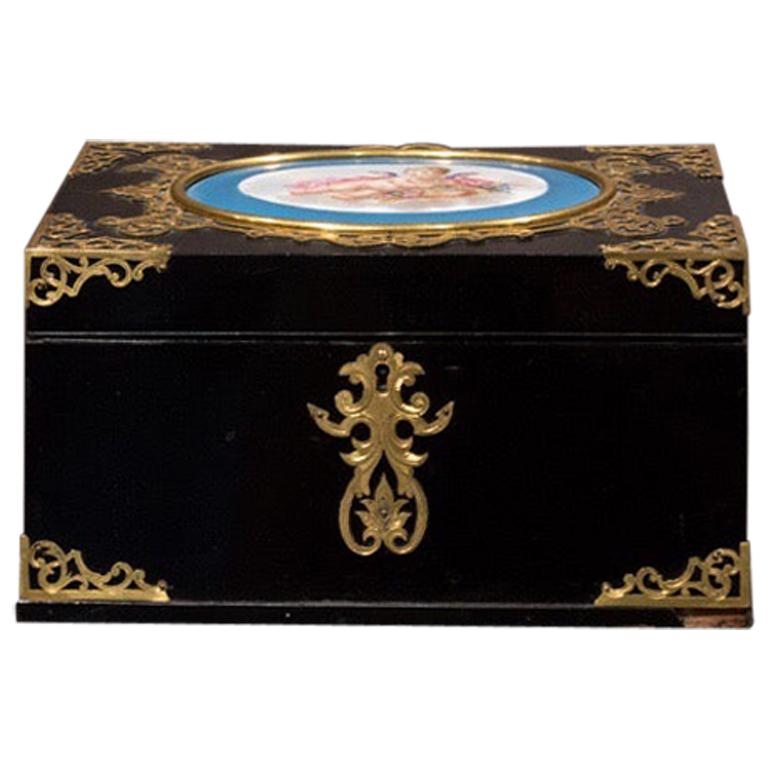 A rare antique French black lacquered casket box with beautiful guilted brass inlays.
Unique Sévres porcelain plaque cartouche depicting a ‘putto’.
Original label in its inner part “Jean-Alain Bidegand. 9, rue de la Tour Paris”,
Late 19th