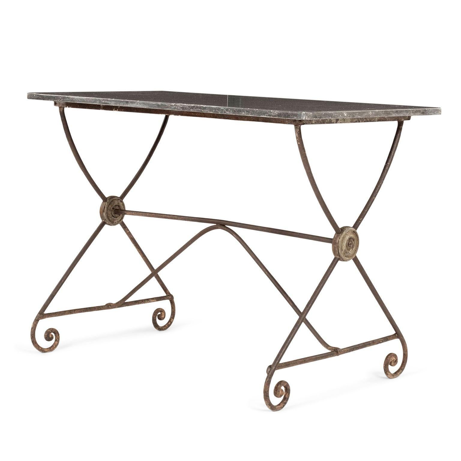 19th century rectangular iron trestle table and bluestone top circa 1870-1889, France. Neoclassical style forged iron trestle base supported by scrolled feet. Later black color bluestone rectangular top speckled with soft white/light gray veining.